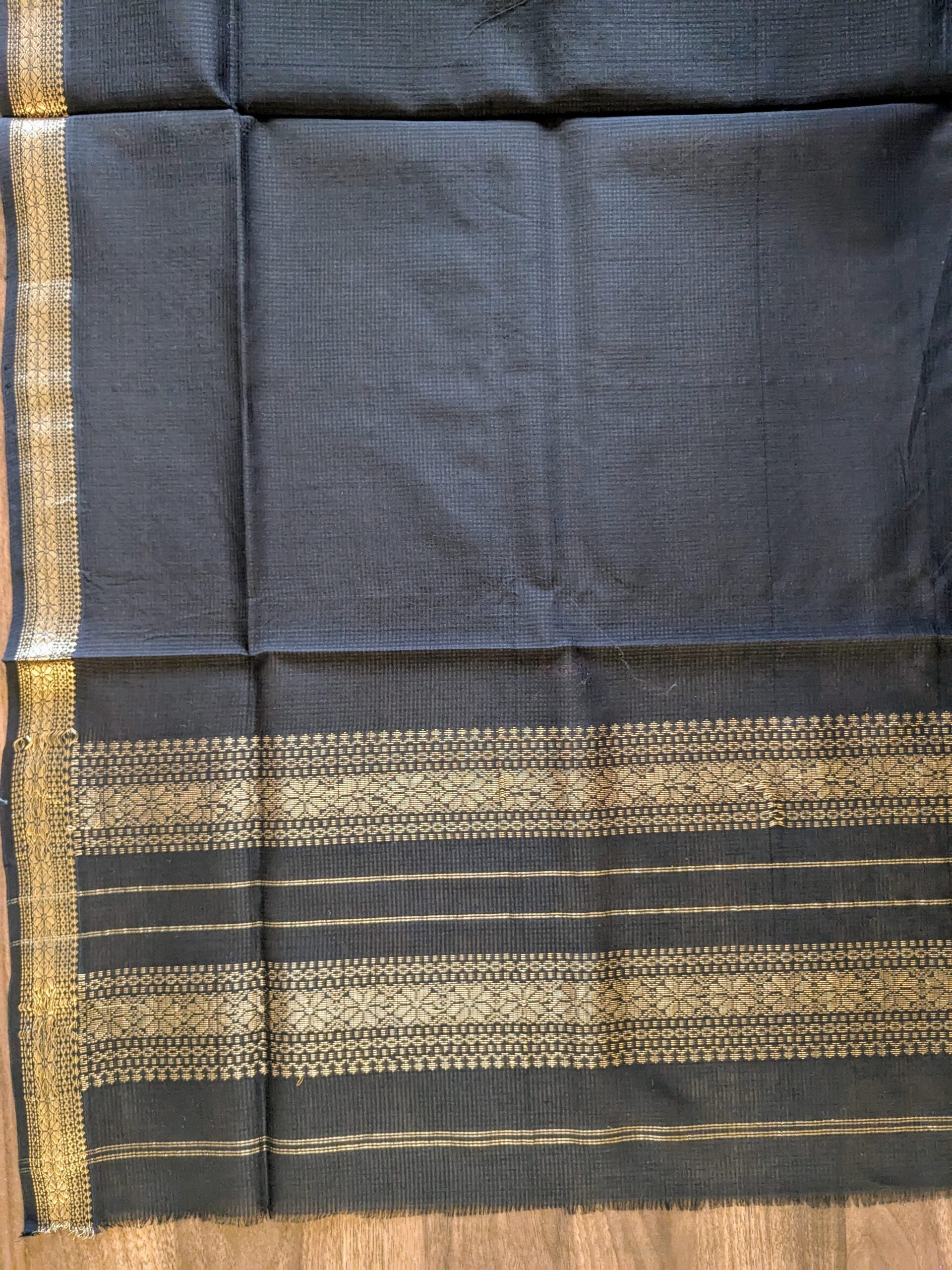 Detailed shot of vintage-style pallu with refined weaving in muted tones.