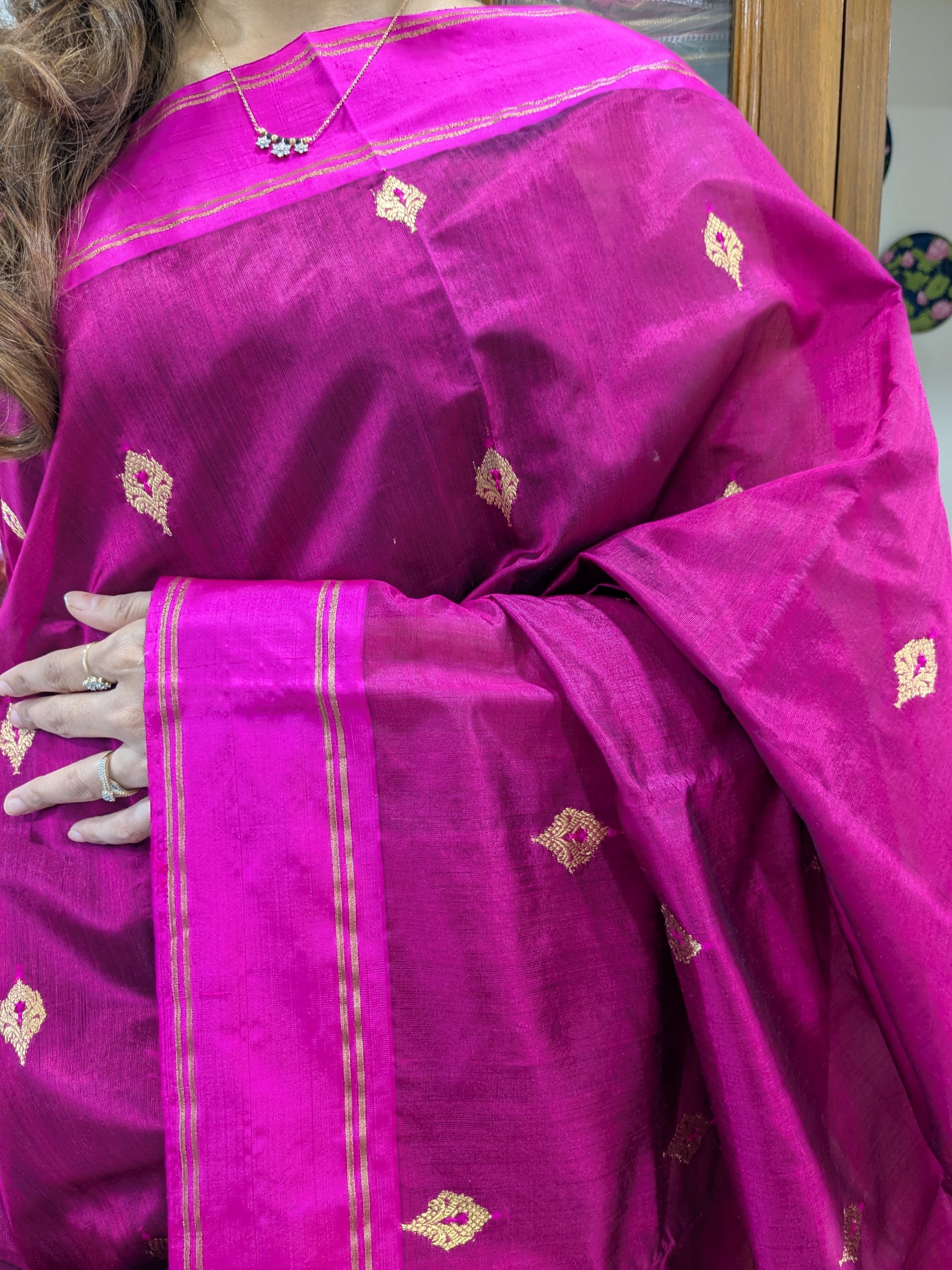 Close-up of Deep Magenta Chanderi silk saree with floral motifs and handwoven medium border.