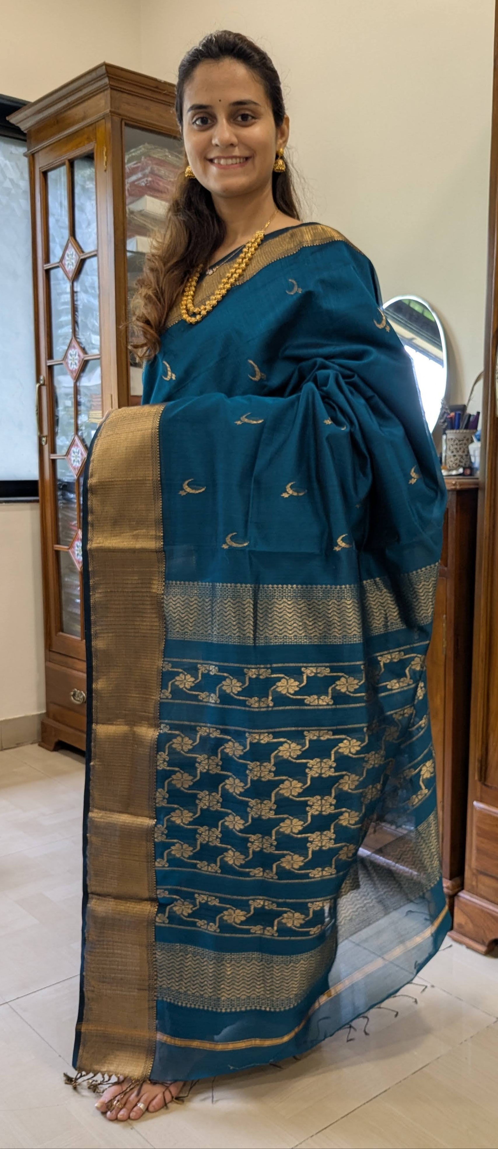Full front view showcasing festive ocean blue silk-cotton saree with elegant wide and narrow borders.