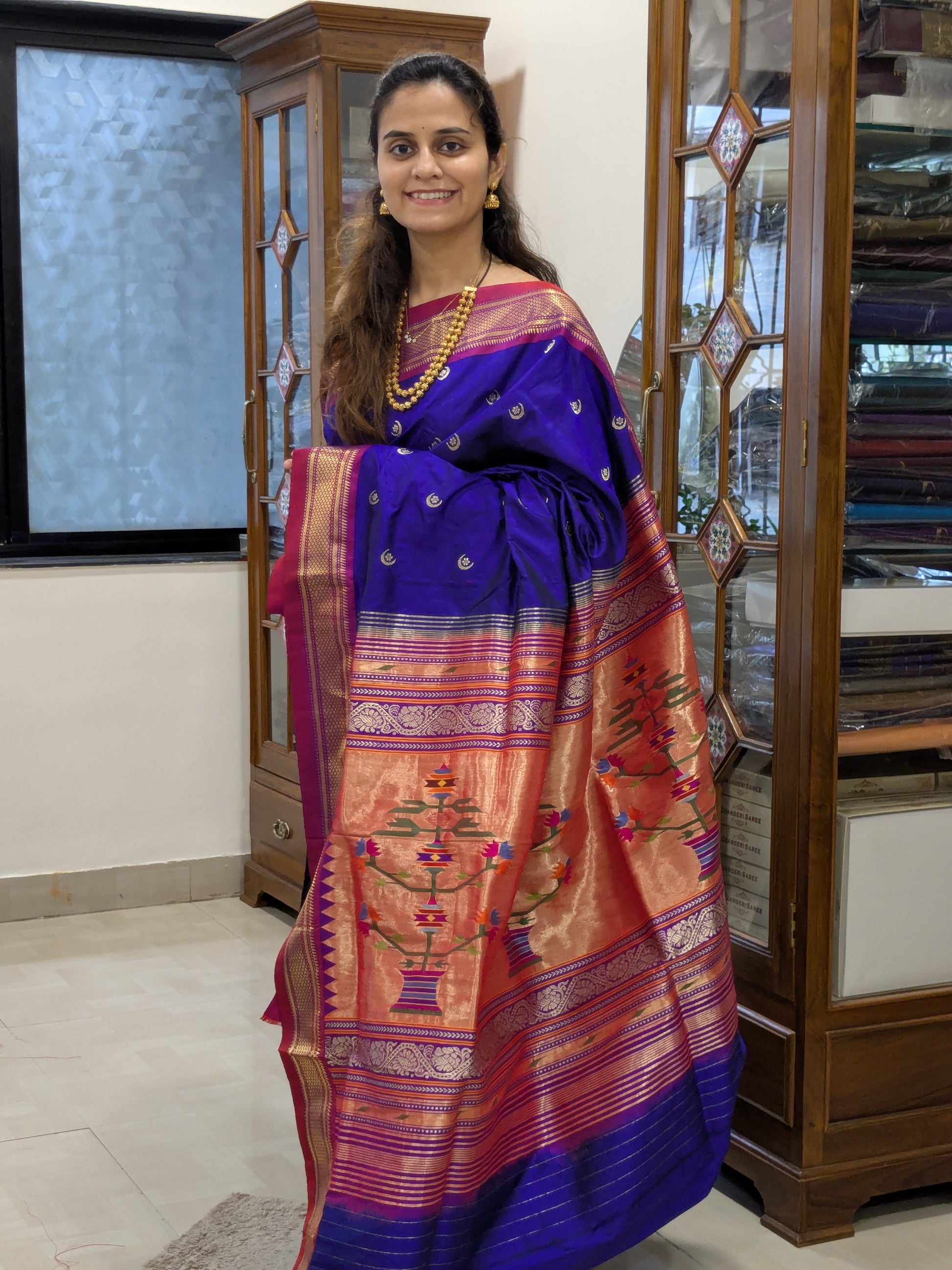 Full front view of rich bluish-purple Paithani saree exuding bridal elegance.