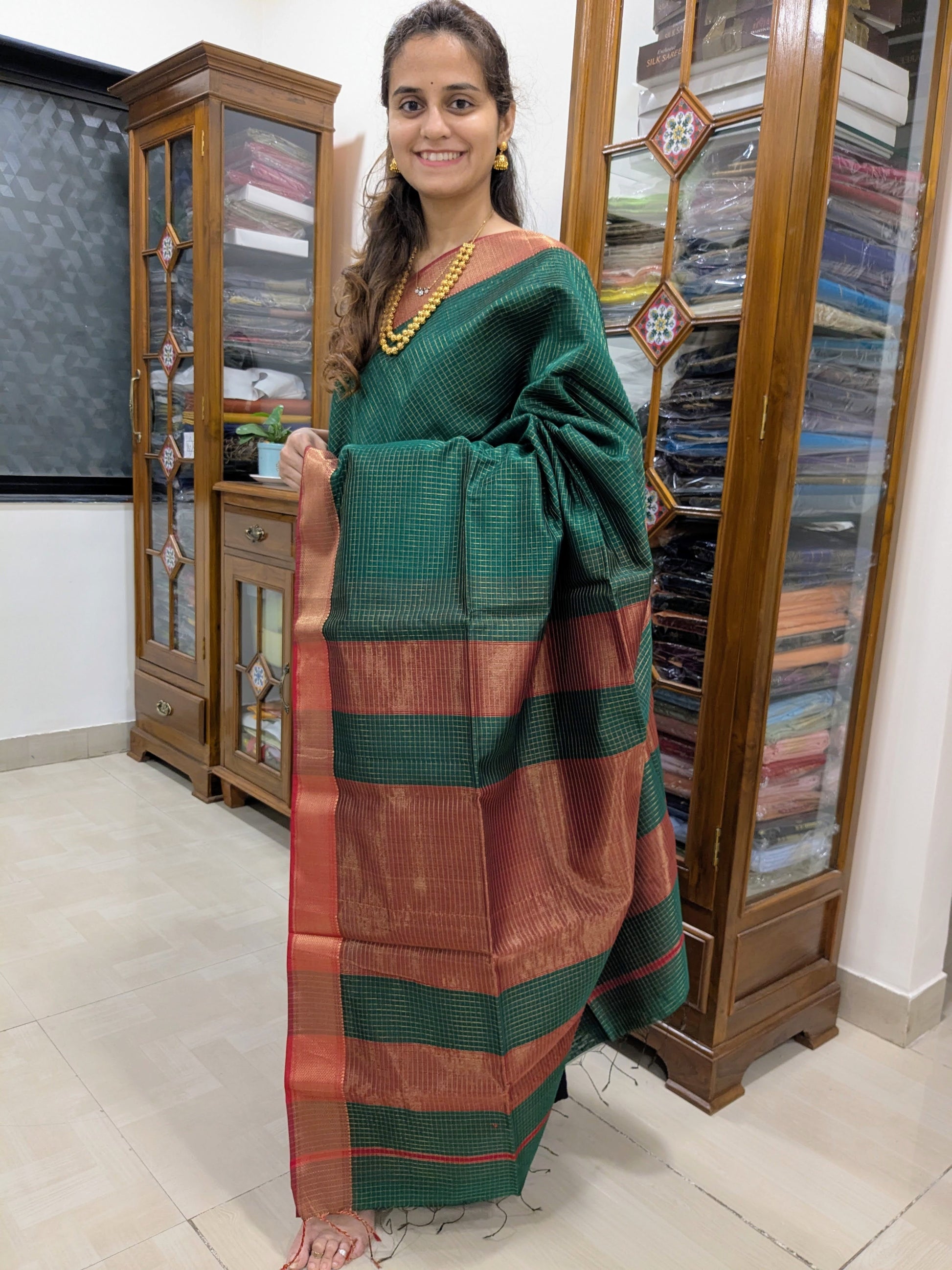 Full front view of festive fresh green handloom Maheshwari saree featuring shimmering golden checks and classic styling.