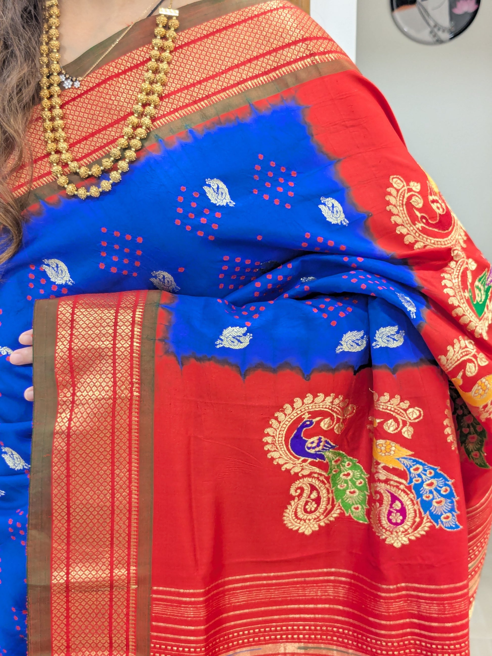 Close-up of royal blue pure silk Paithani with bandhani pattern, peacock butti, and Narali border.
