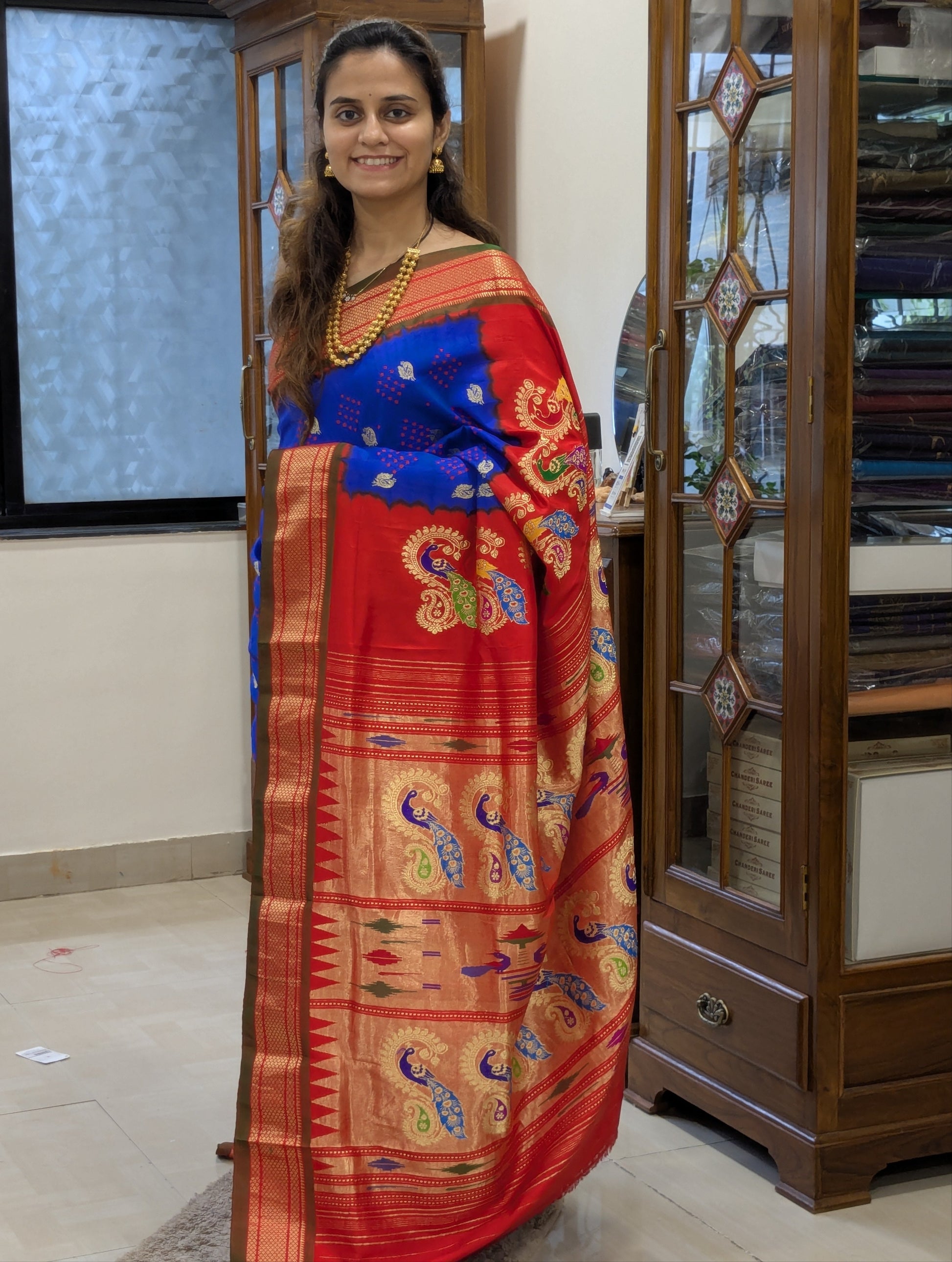 Full front view of elegant royal blue Paithani saree radiating festive charm.
