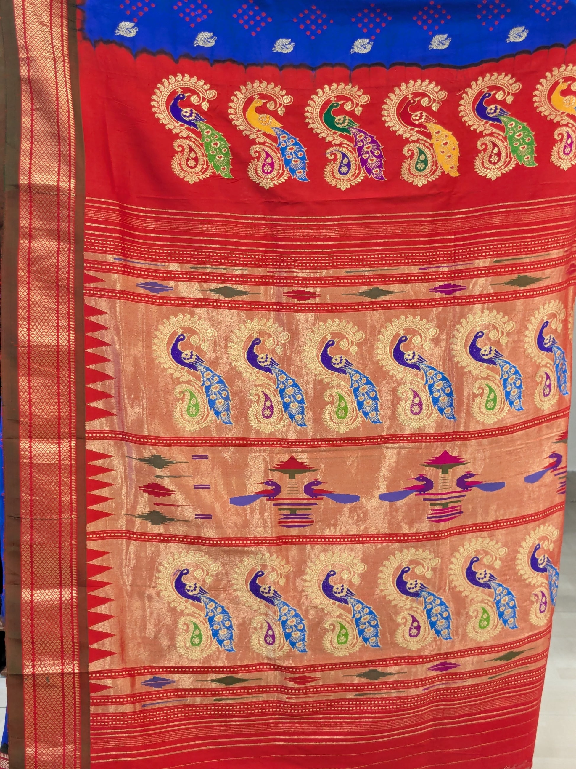 Detailed pallu with exquisite Meena peacocks in vibrant colors.