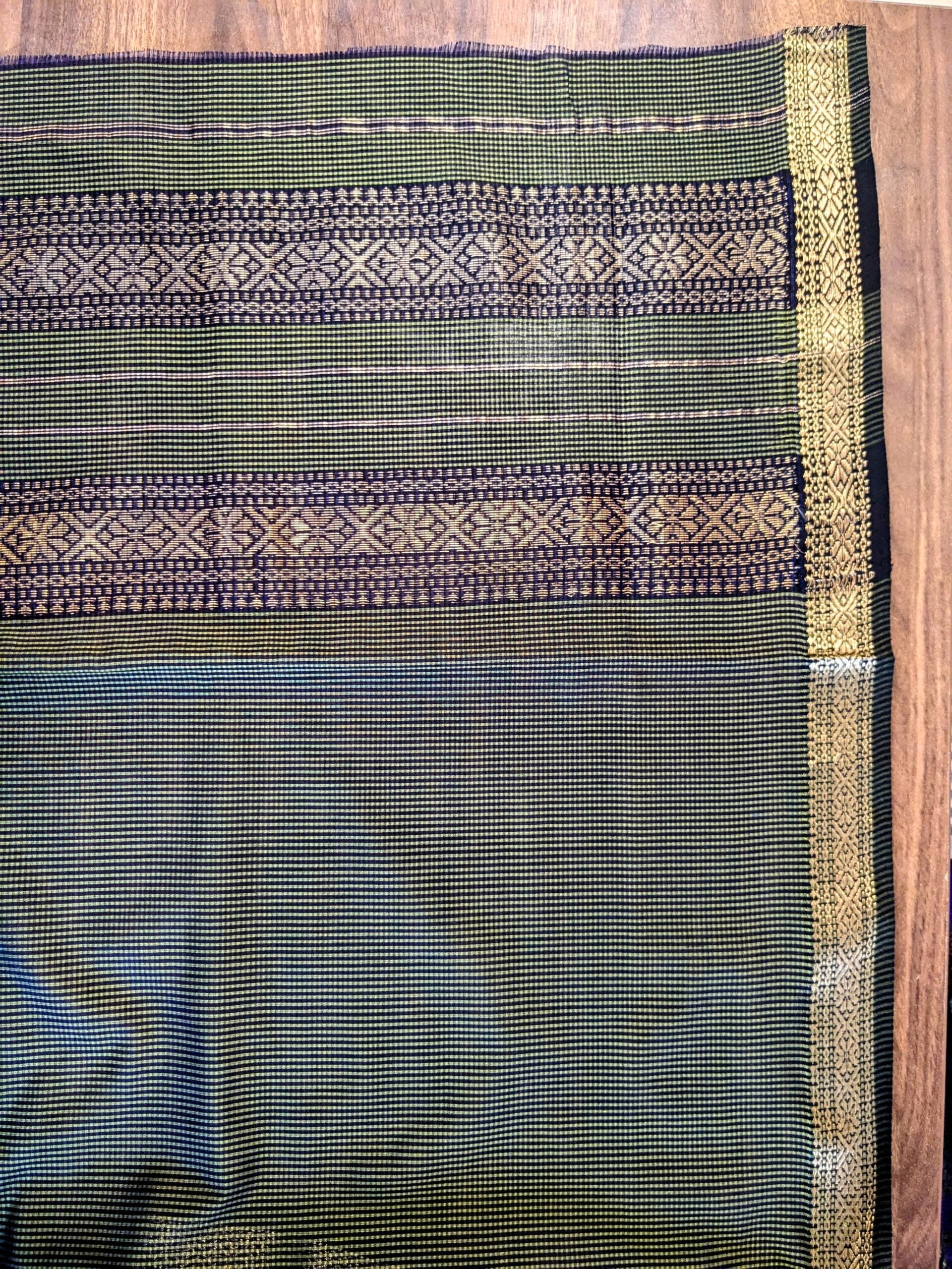 Detailed image of vintage pallu in olive green with fine handloom craftsmanship.