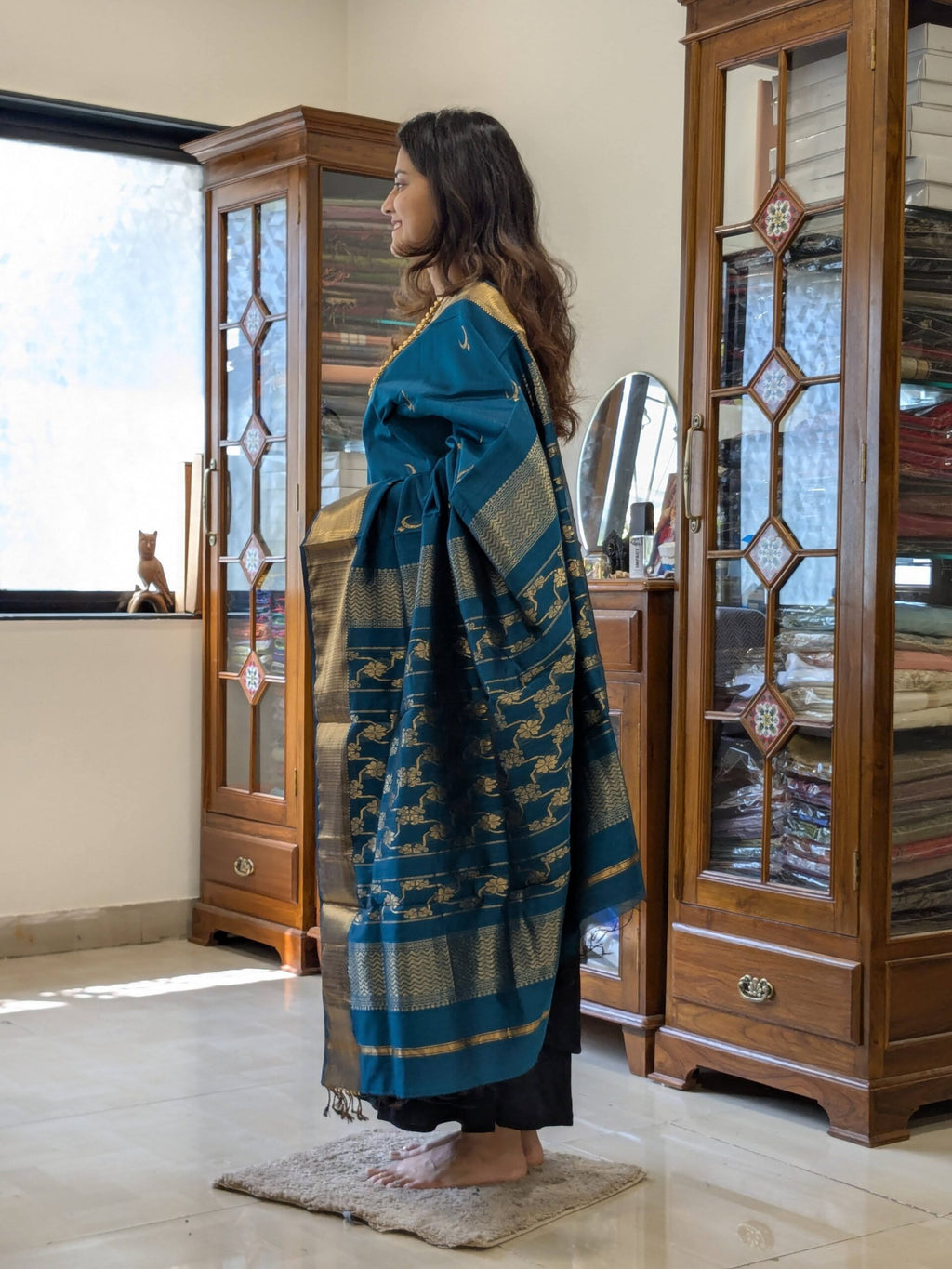 Side view of handloom saree highlighting fluid drape, vibrant color, and intricate motif work.