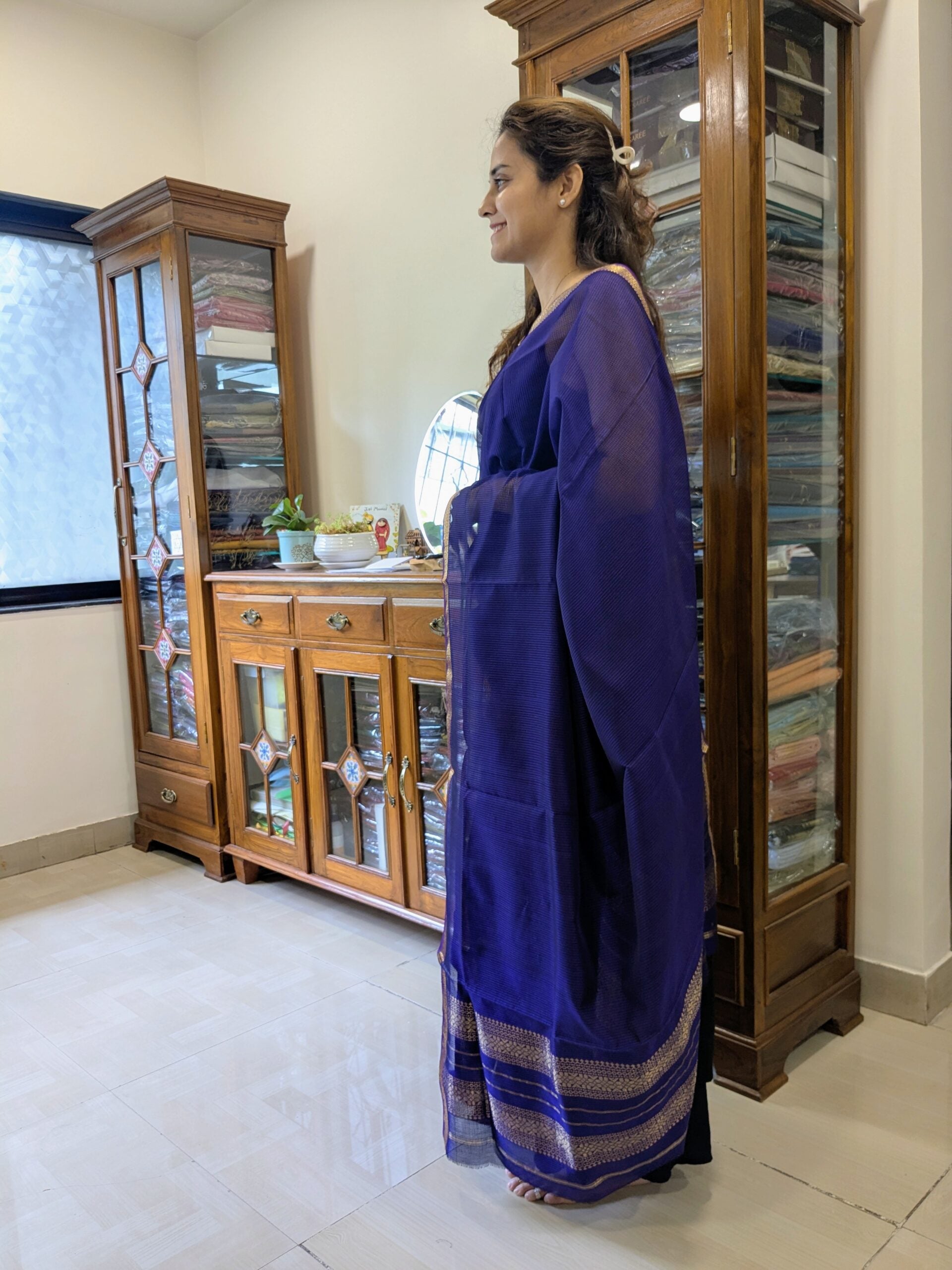 Side view of lightweight purple saree highlighting smooth drape, traditional weave, and subtle sheen.
