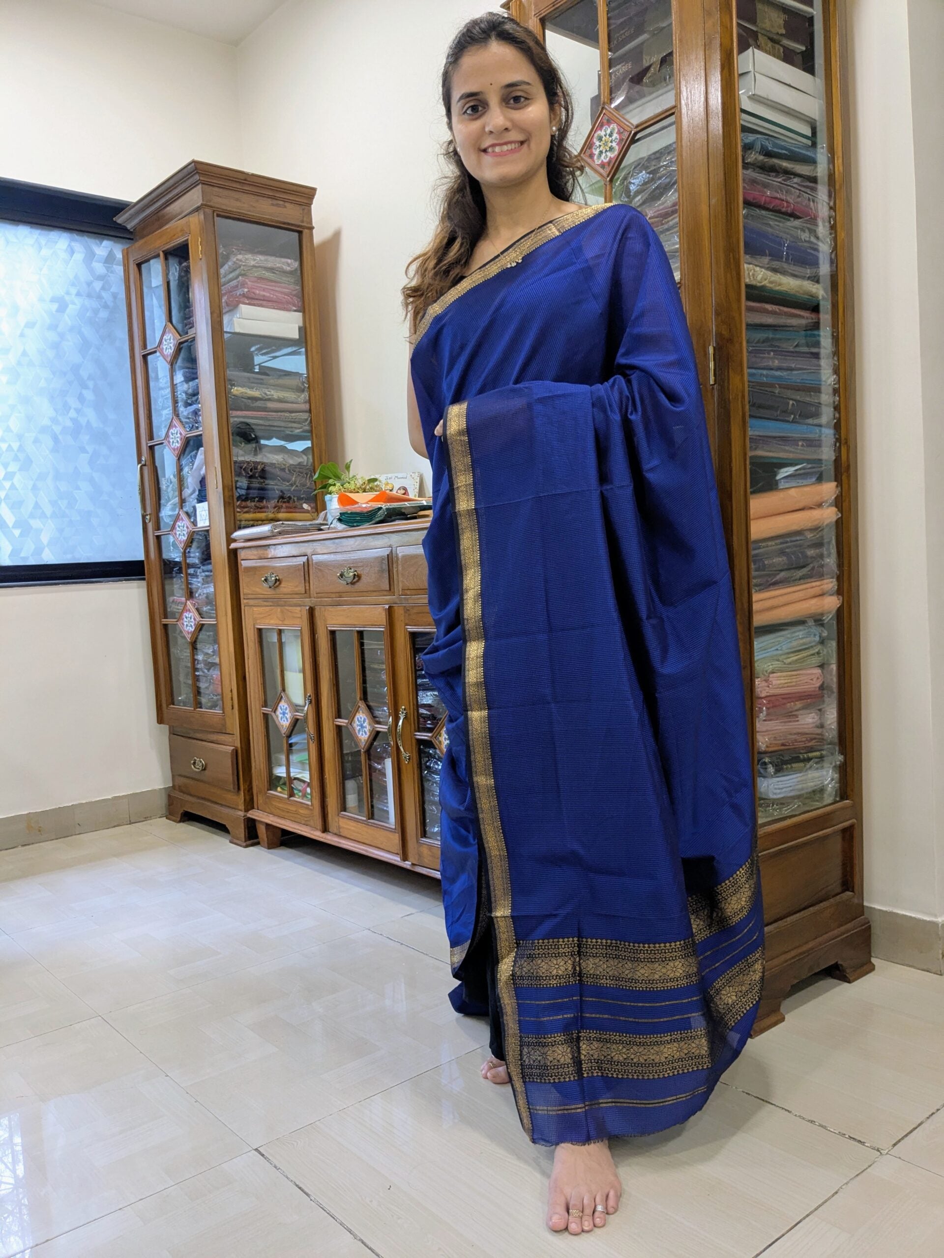 Full front view of royal blue handloom Maheshwari saree featuring classic check pattern and traditional finish.  