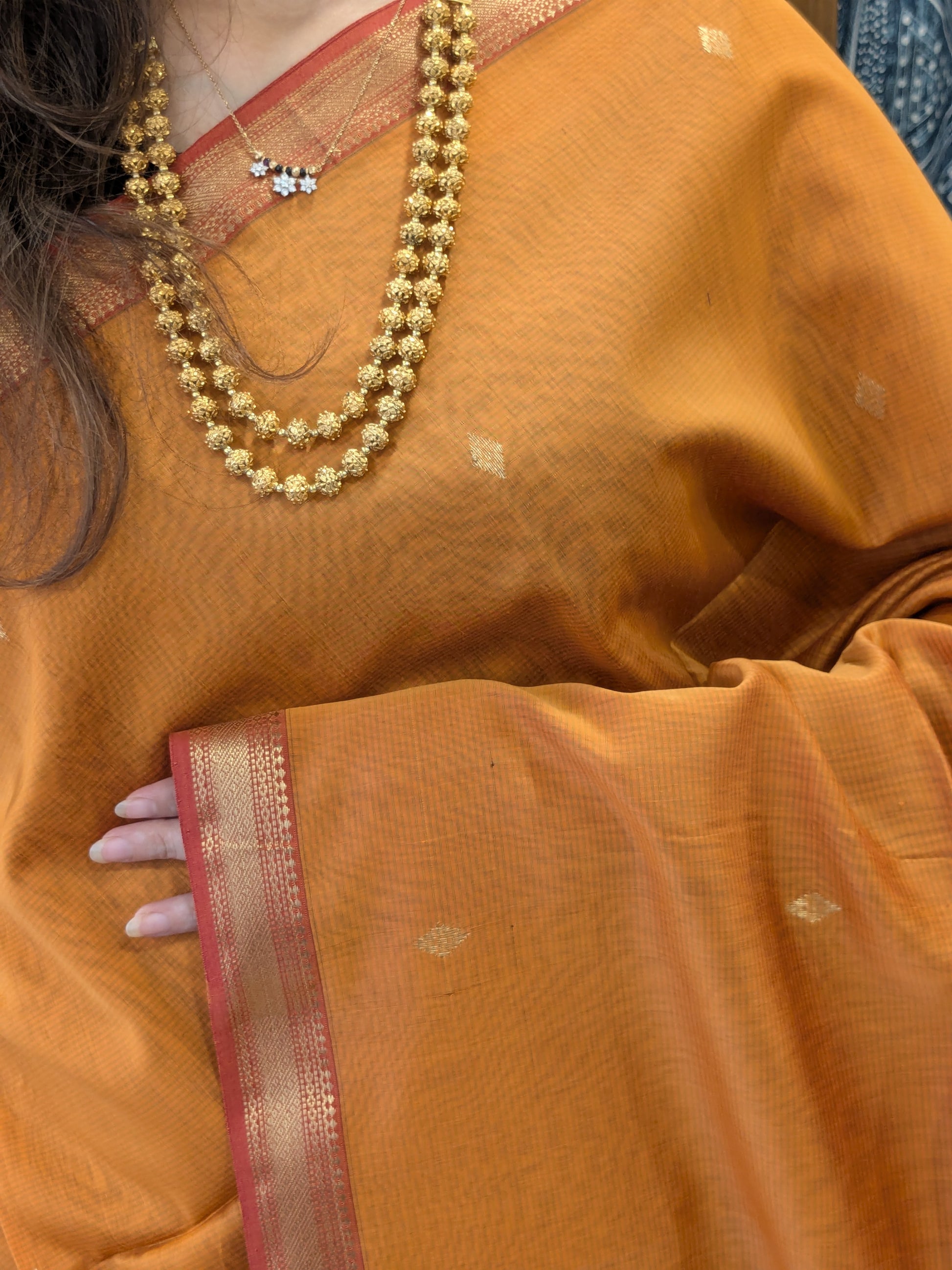 Orange Maheshwari Silk Cotton Saree with Red Buttidar Pallu