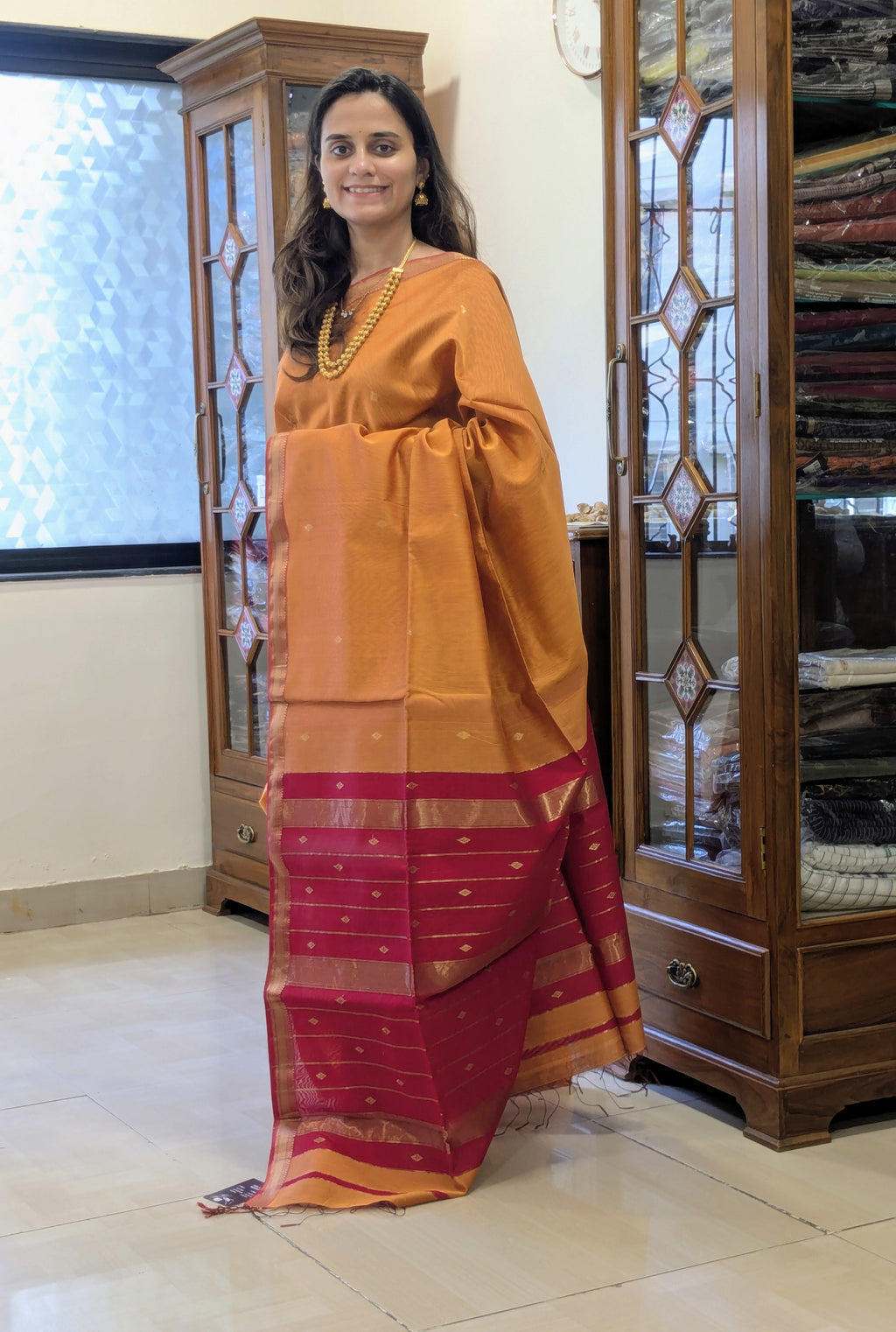 Orange Maheshwari Silk Cotton Saree with Red Buttidar Pallu