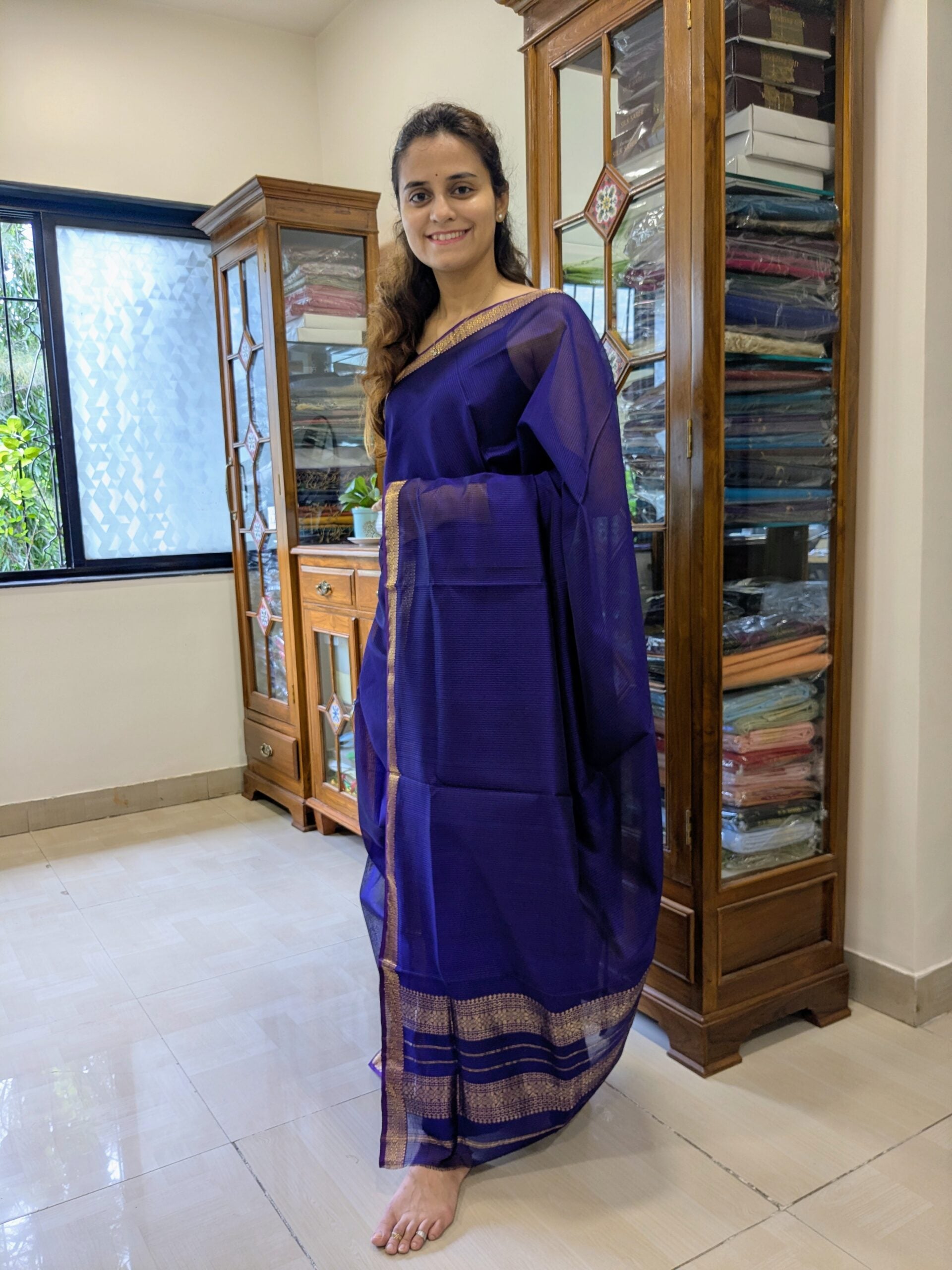 Full front view of elegant purple handloom Maheshwari saree showcasing classic check pattern and rich texture. 