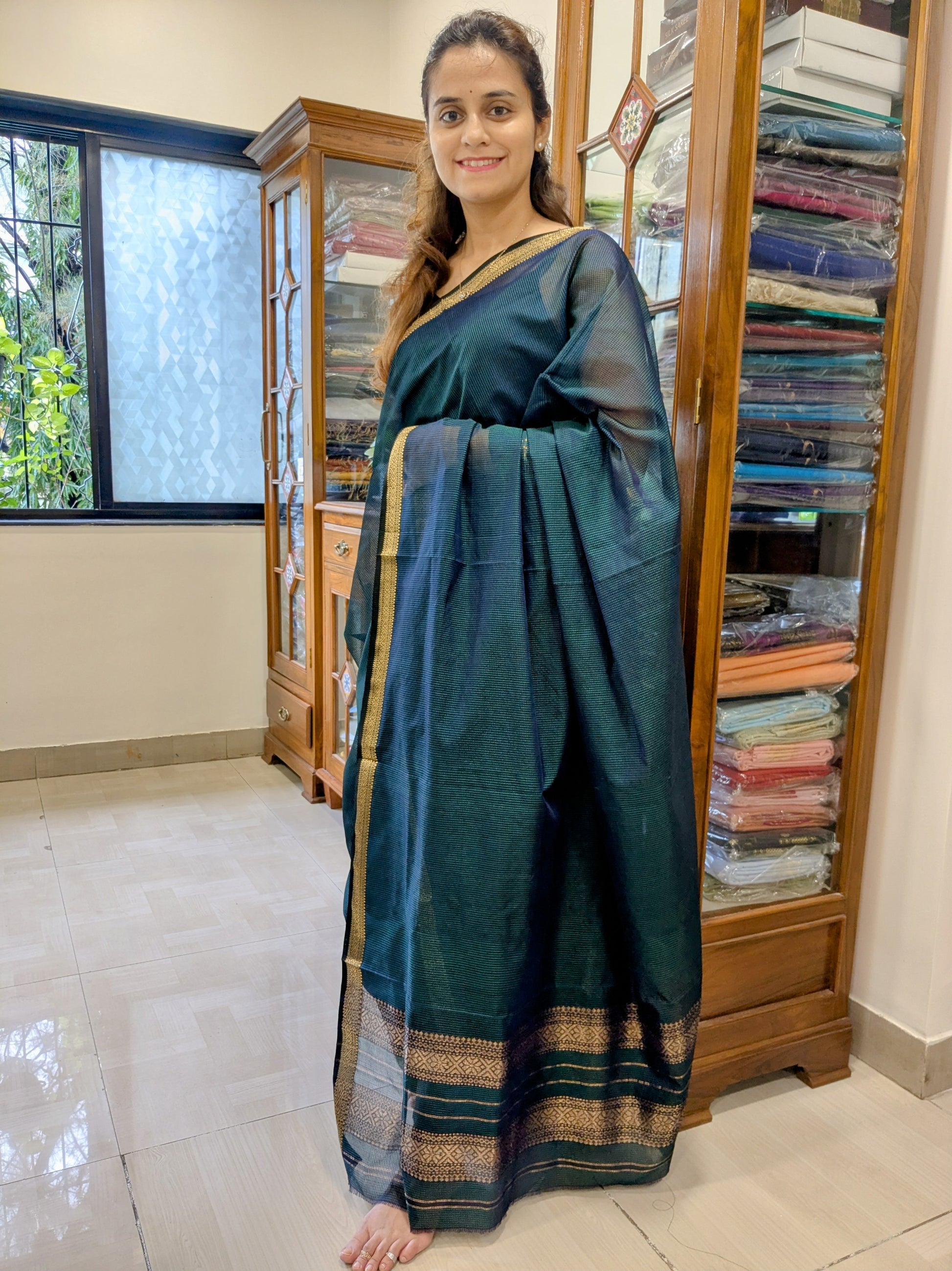 Full front view of bottle green handloom Maheshwari saree featuring classic check pattern and traditional elegance.