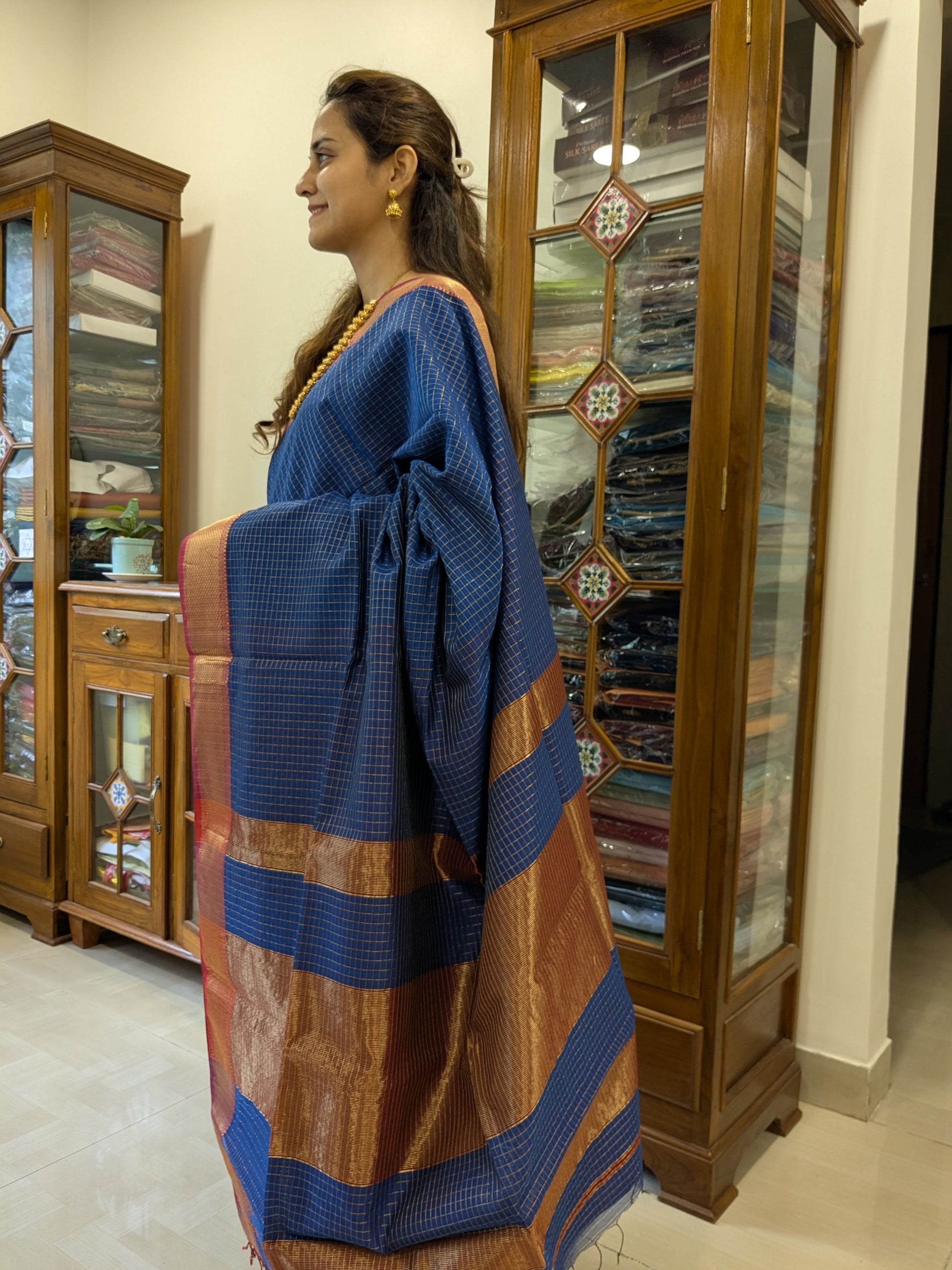 Side view of grey saree showcasing graceful drape, traditional weave, and rich silk-cotton texture