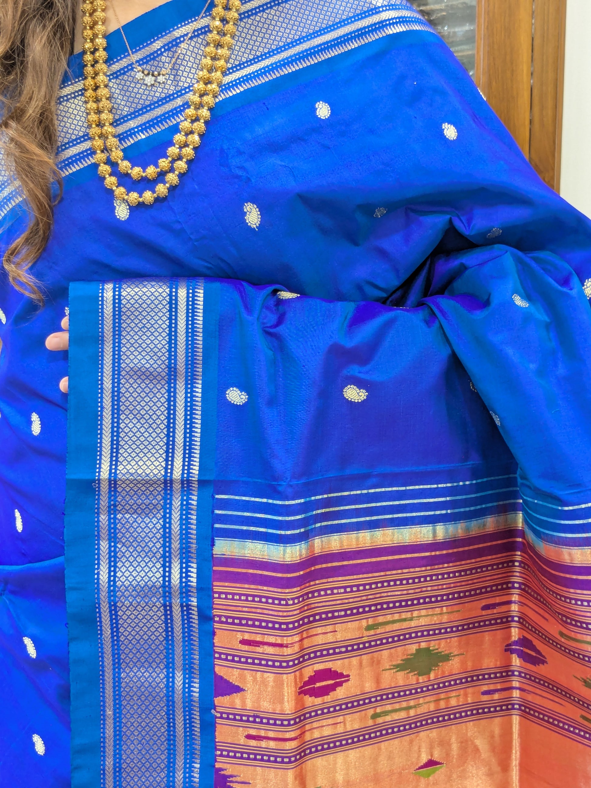 Close-up of the Blue Orchid Paithani – a rich blend of Koyri motifs and luminous pure silk.