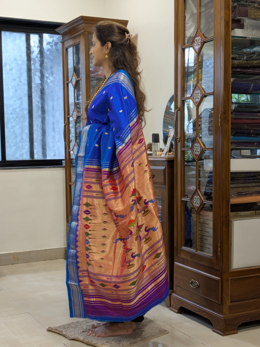 Side view highlighting the graceful drape and the signature Narali border in motion.