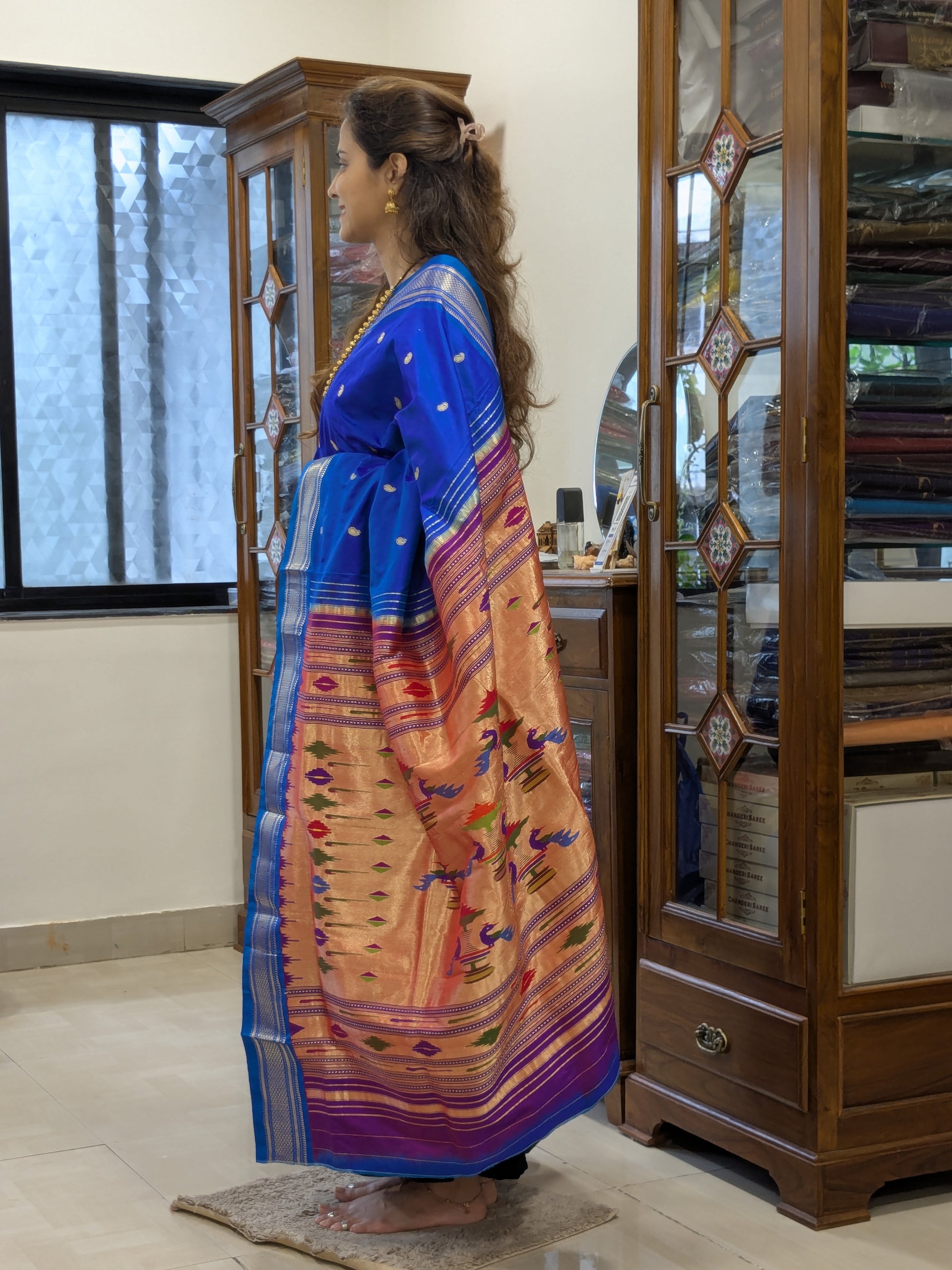 Side view highlighting the graceful drape and the signature Narali border in motion.