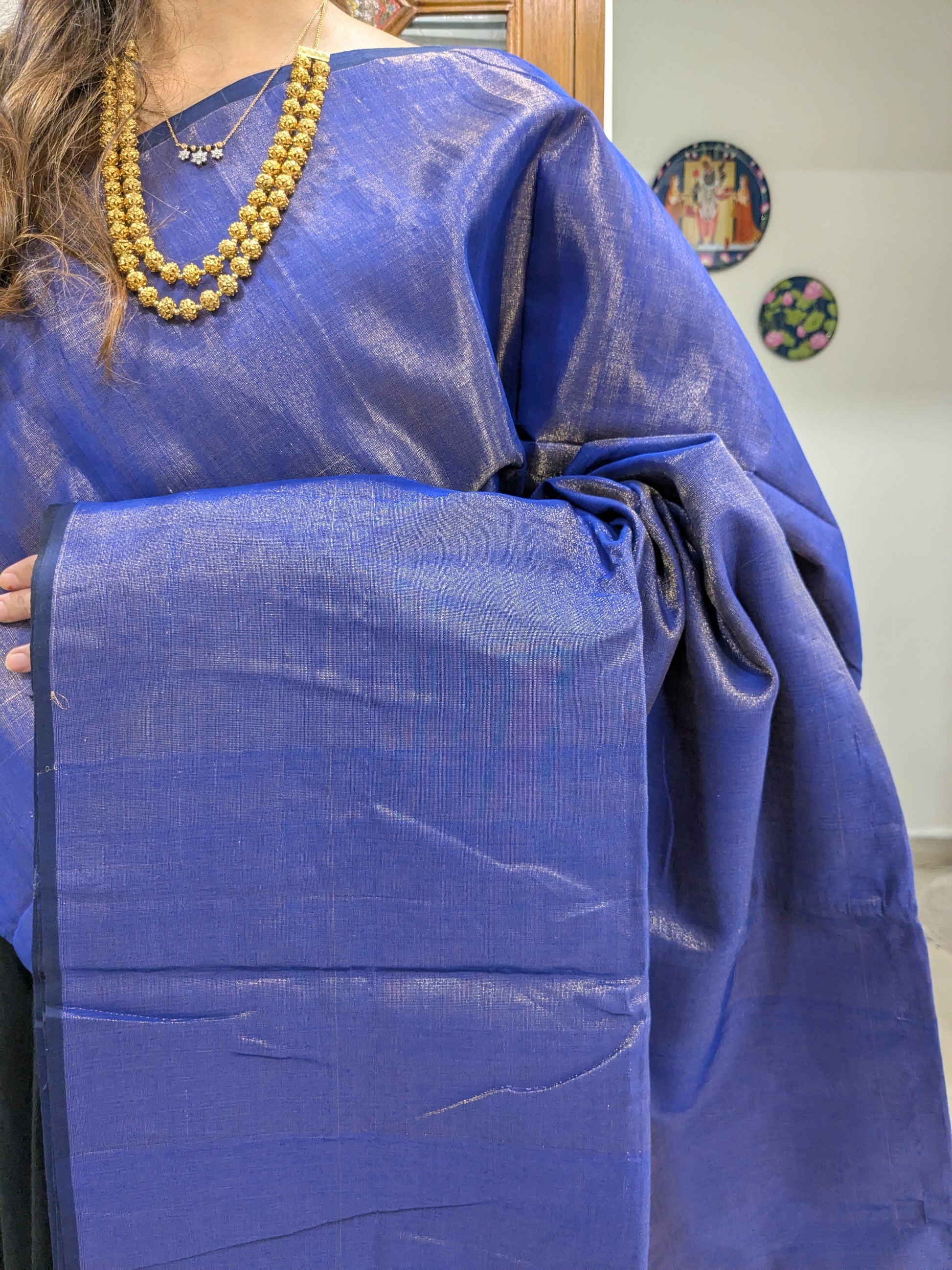 Close-up of ink blue Maheshwari saree in tissue-cotton with plain weave and subtle handloom texture.