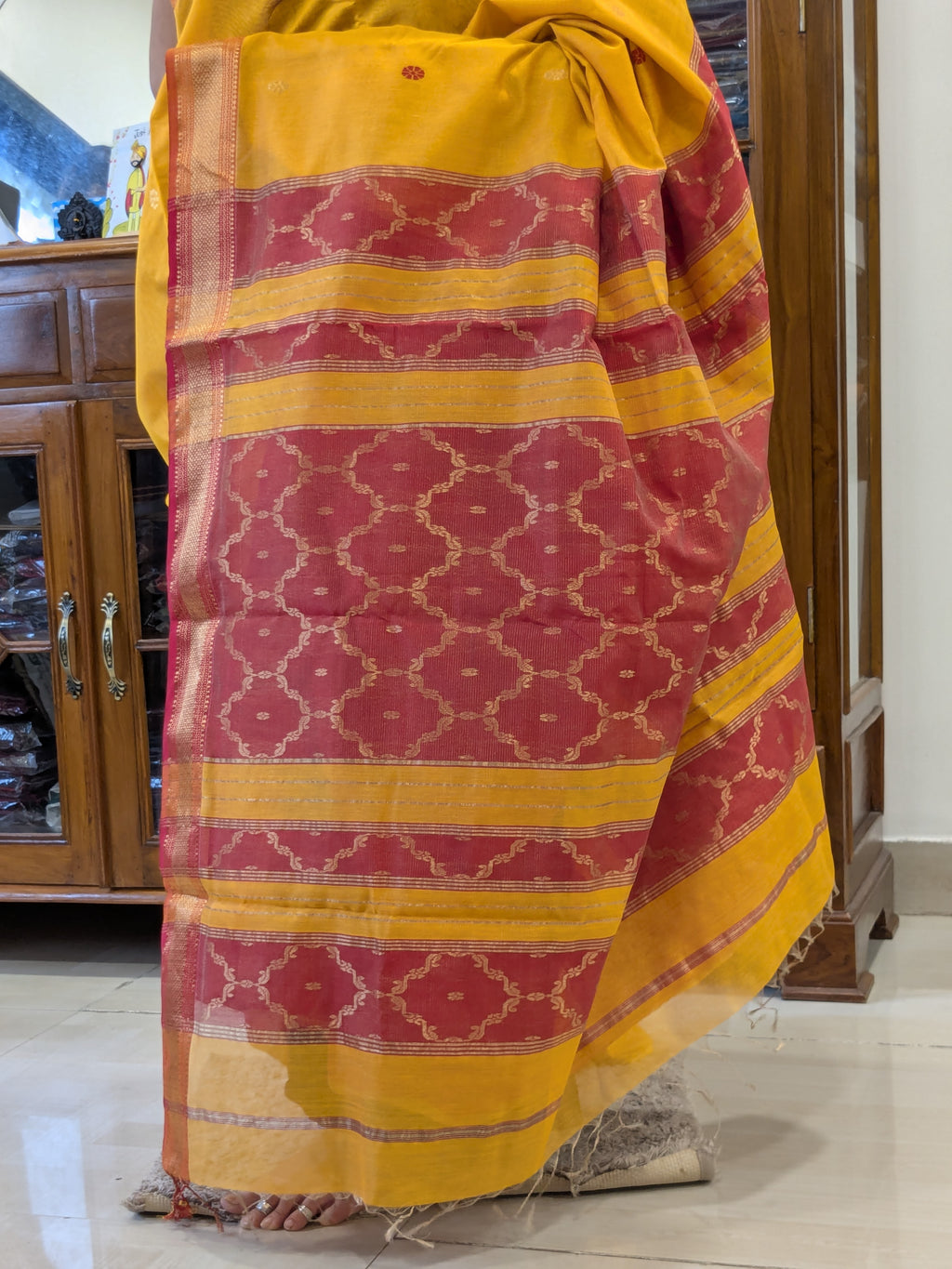 Intricate jaali pallu in yellow silk tissue with traditional craftsmanship.