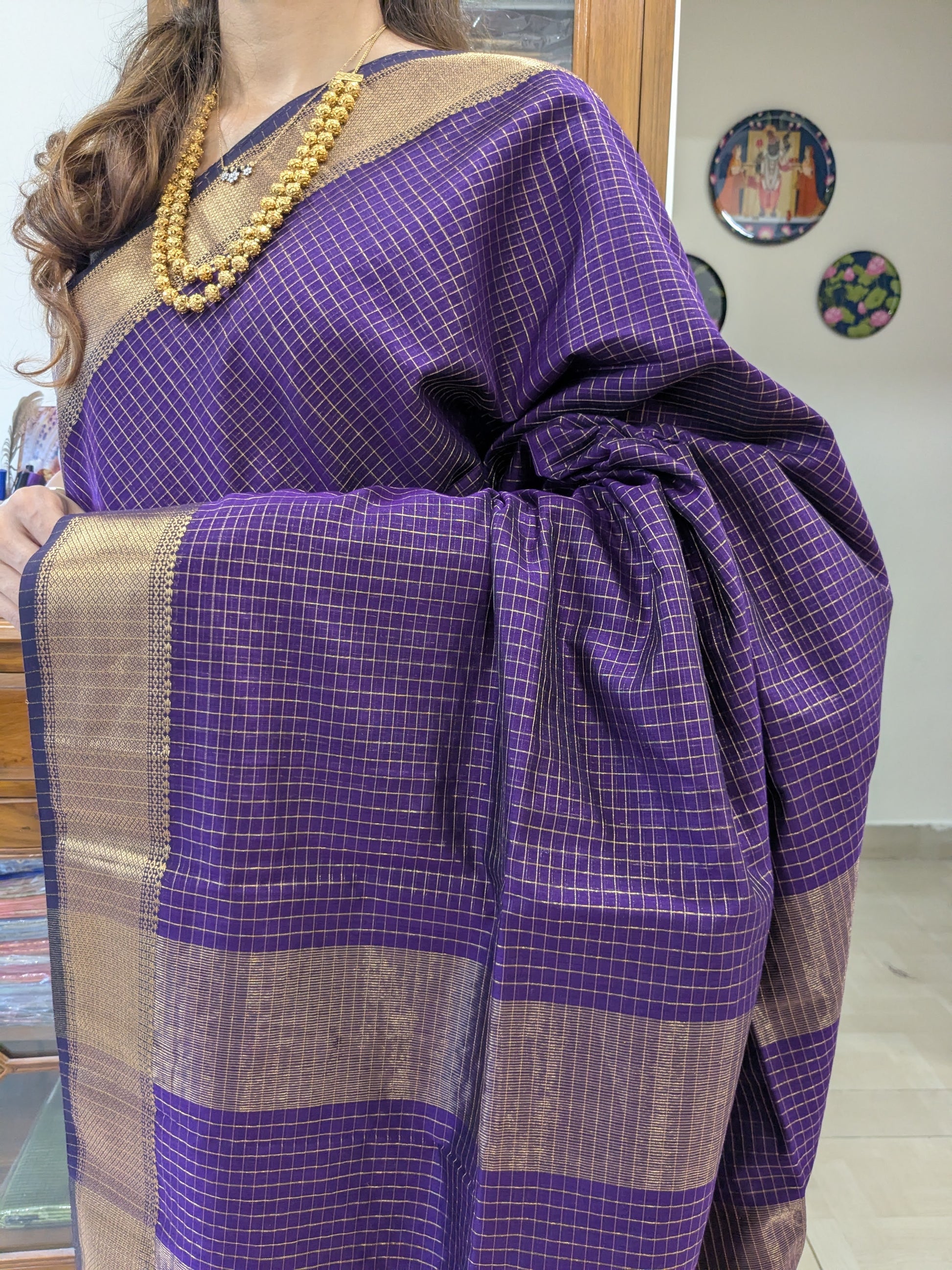 Close-up of purple Maheshwari silk-cotton saree with zari checks, medium border