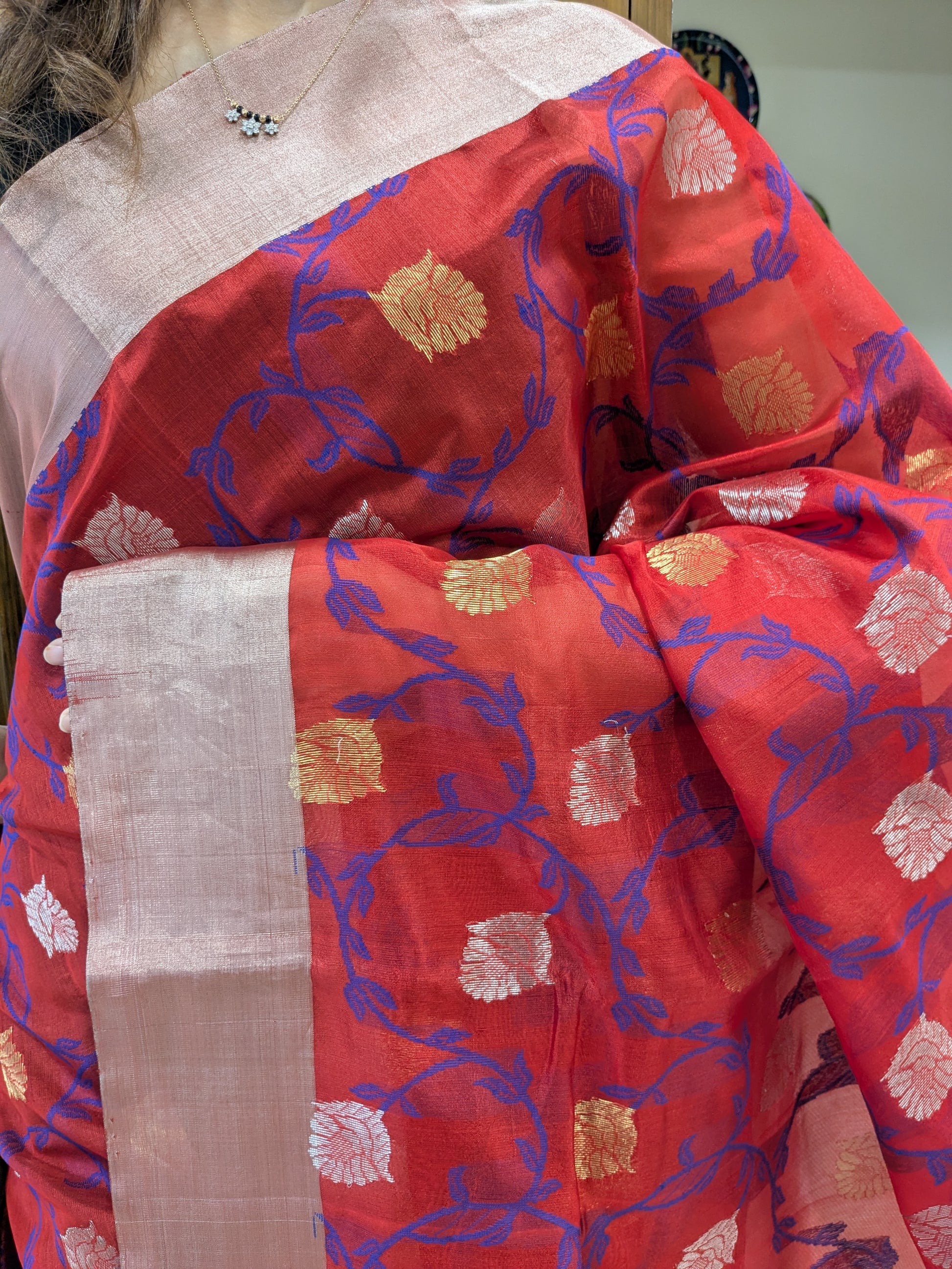 Close-up of Red Chanderi silk saree with floral trails, handloom weave, and medium border detailing.