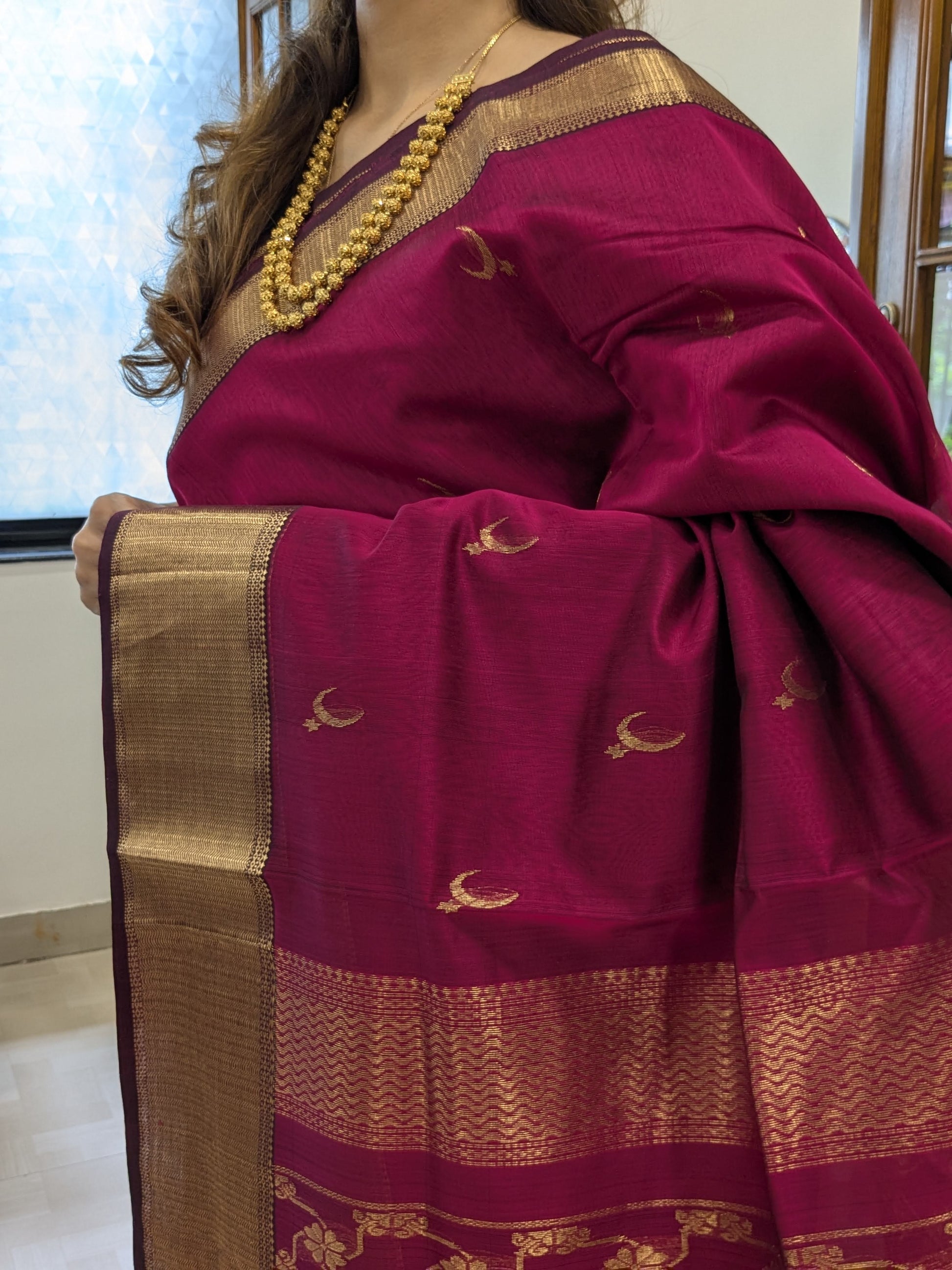 Close-up of Rani Maheshwari saree featuring moon and flower motifs with jaali pallu detailing.