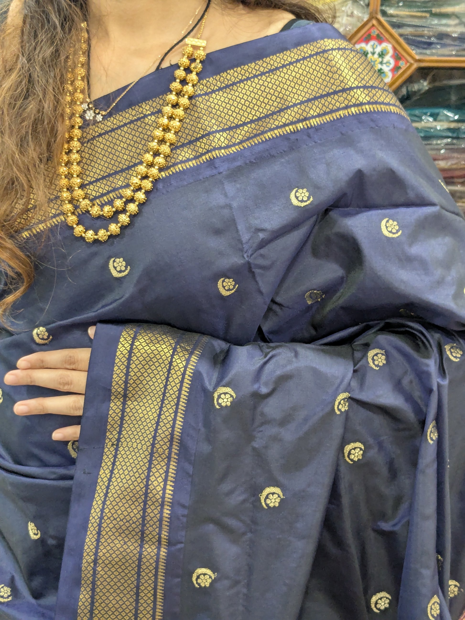 Close-up of jet grey pure silk Paithani saree with moon and flower butti and classic Narali border.