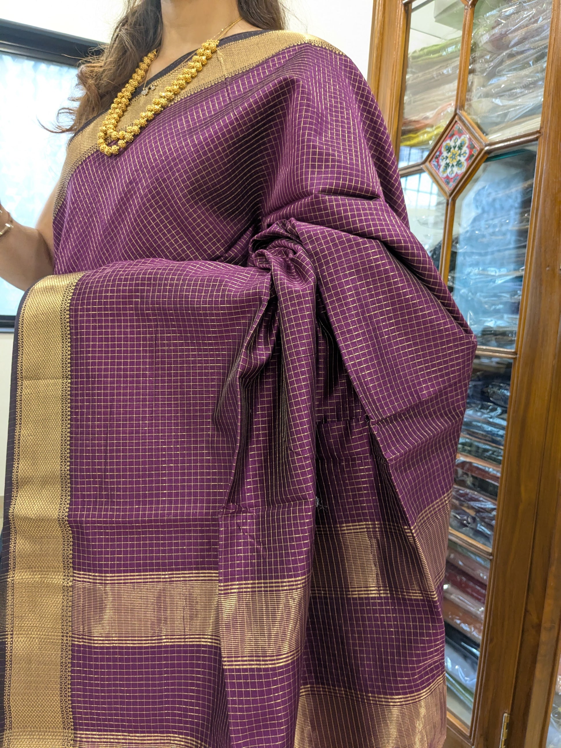 Close-up of wine Maheshwari silk-cotton saree with zari checks, medium border