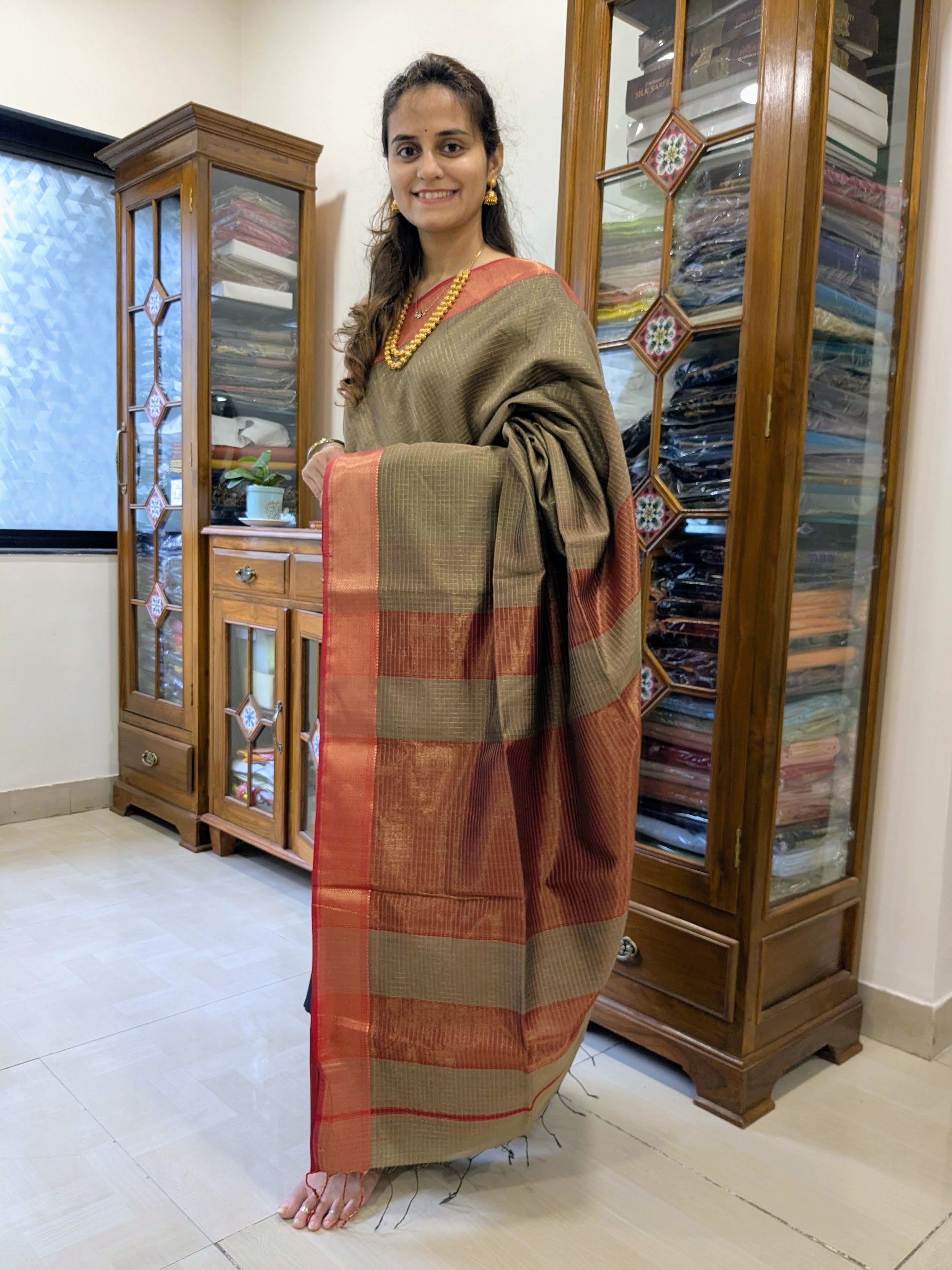 Full front view of festive grey handloom Maheshwari saree featuring golden zari check detailing and smooth finish.