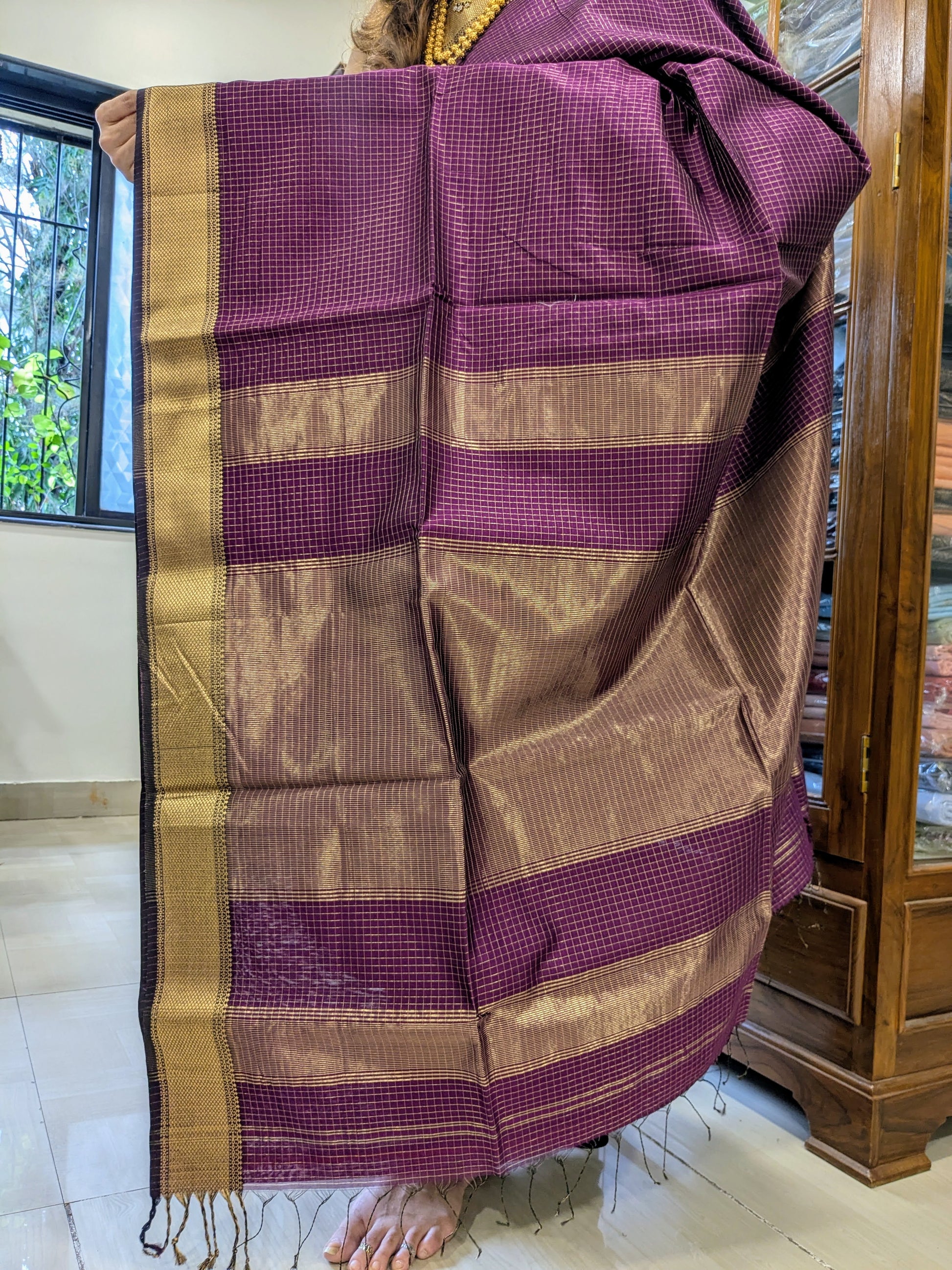 Detailed image of zari-checked pallu with fine golden threads in signature Maheshwari style.