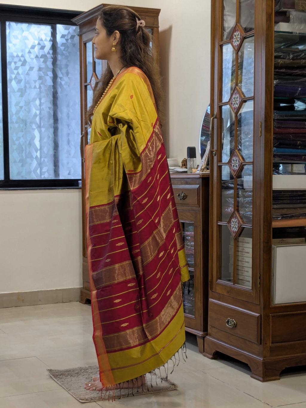Side view showing elegant silk drape, detailed buttis, and handloom finesse.