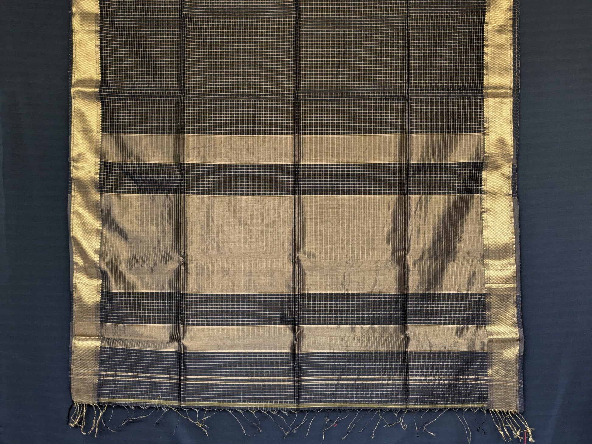 Detailed image of zari-checked pallu showcasing traditional craftsmanship in fine gold threads.