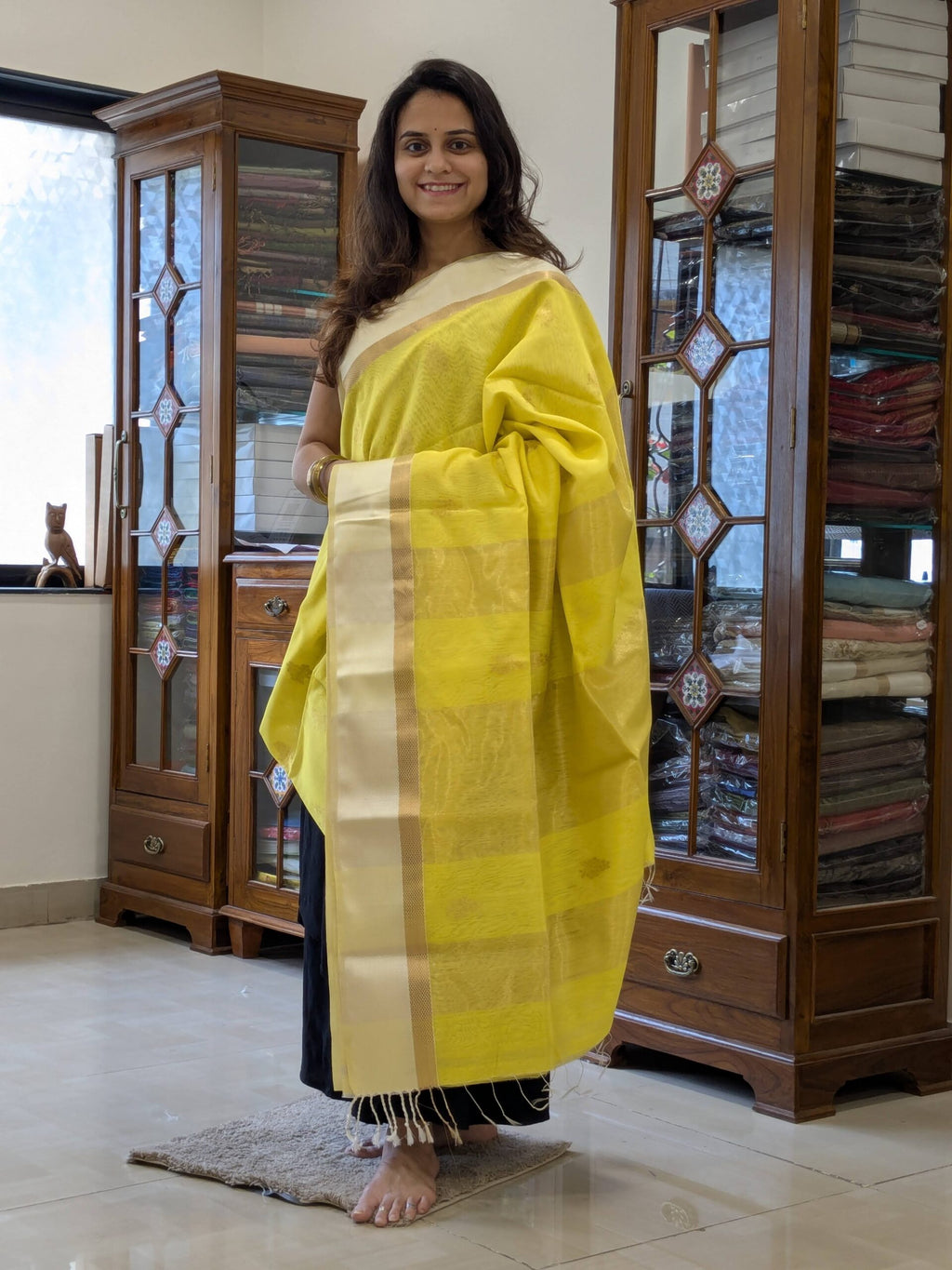 Full front view of vibrant fluorescent yellow handloom Maheshwari saree featuring delicate flower designs and festive charm.  