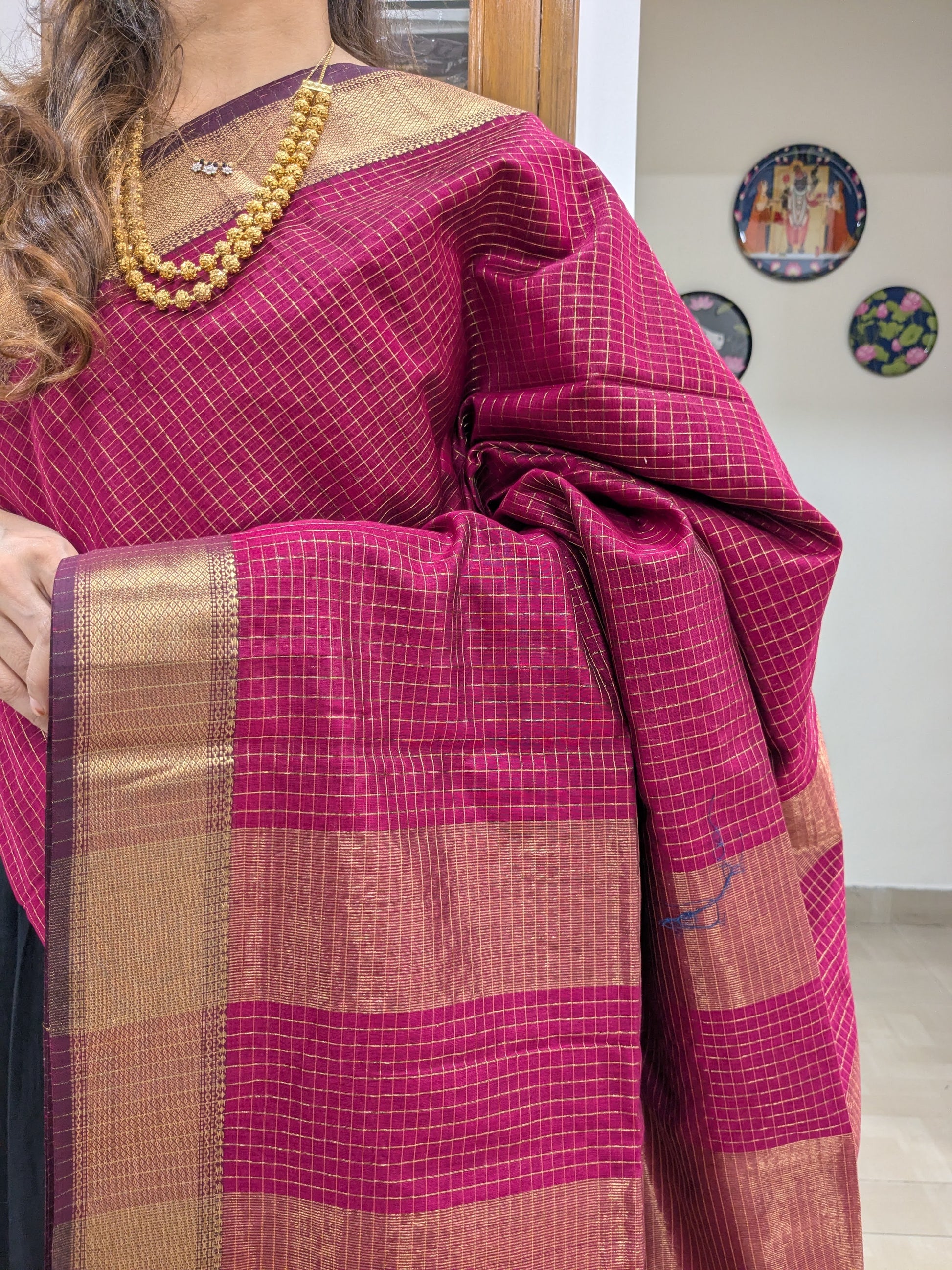 Close-up of Hot Pink Maheshwari saree with silk-cotton base, zari checks, and handwoven medium border.