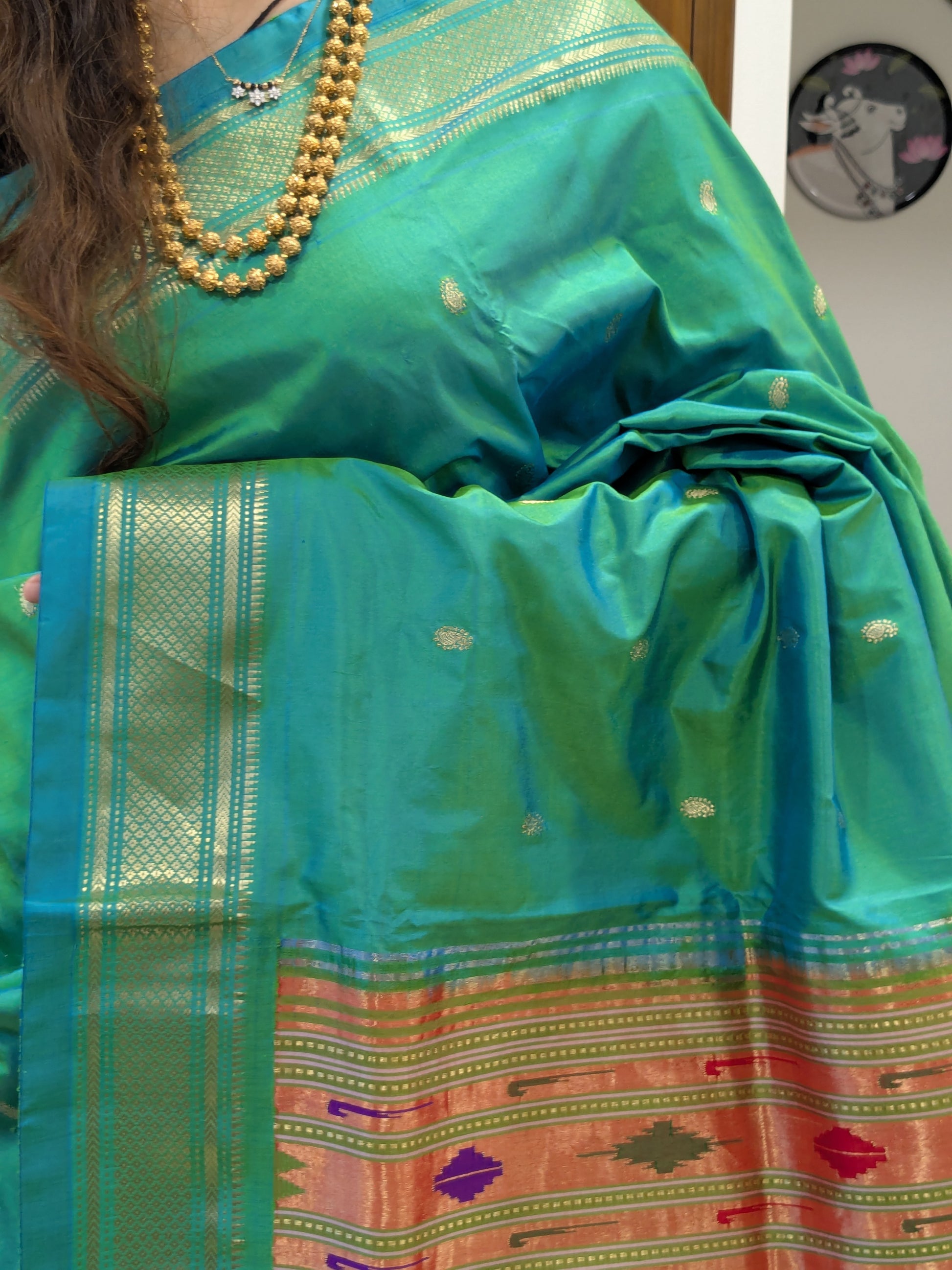 Close-up of the greenish teal Paithani silk – highlighting the Koyri motifs and lustrous handloom texture.