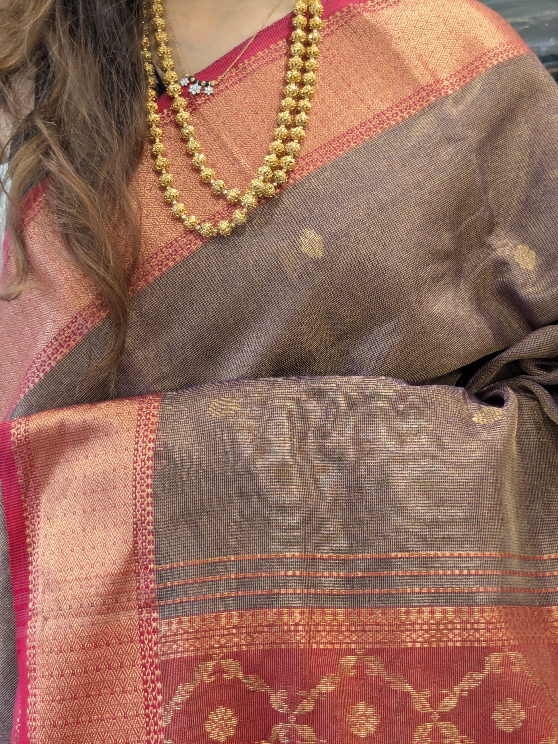 Close-up of Jamun silk tissue Maheshwari saree with flower butti, jaali pallu, and intricate medium border.