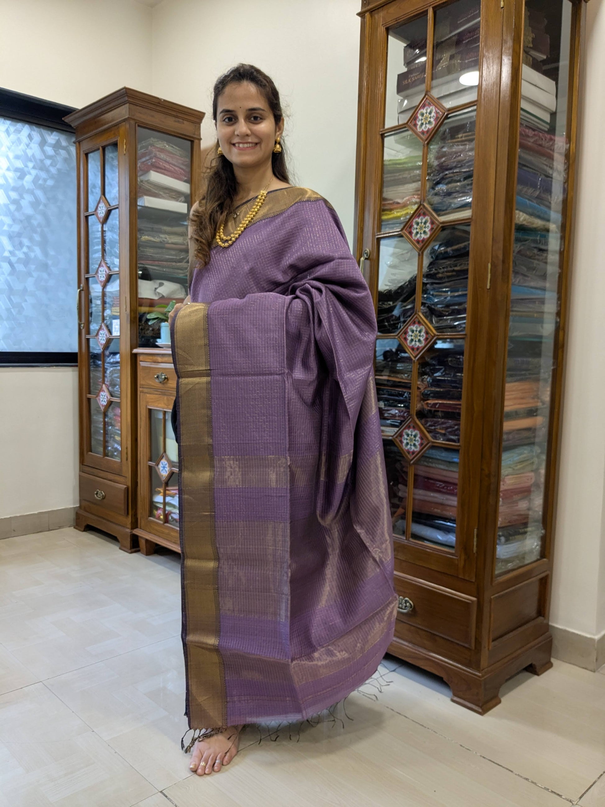 Full front view of elegant lilac handloom Maheshwari saree featuring golden check pattern and festive sheen.