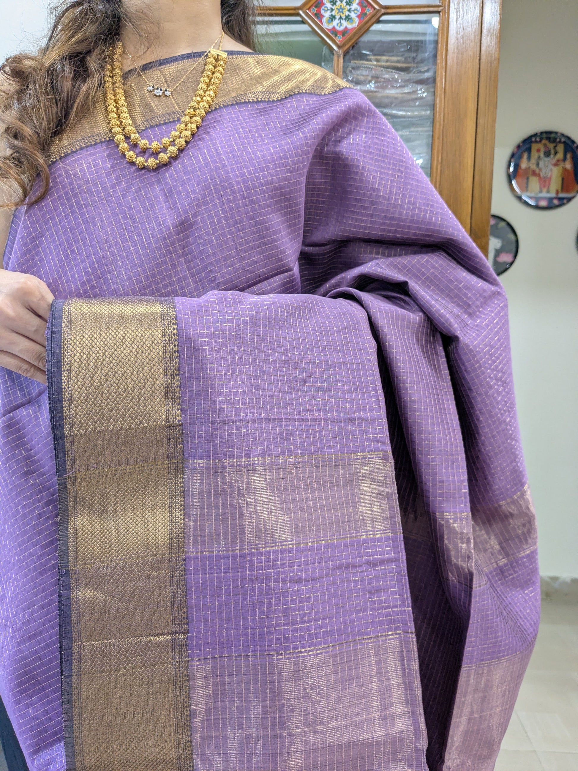 Close-up of lilac Maheshwari silk-cotton saree with zari checks, medium border