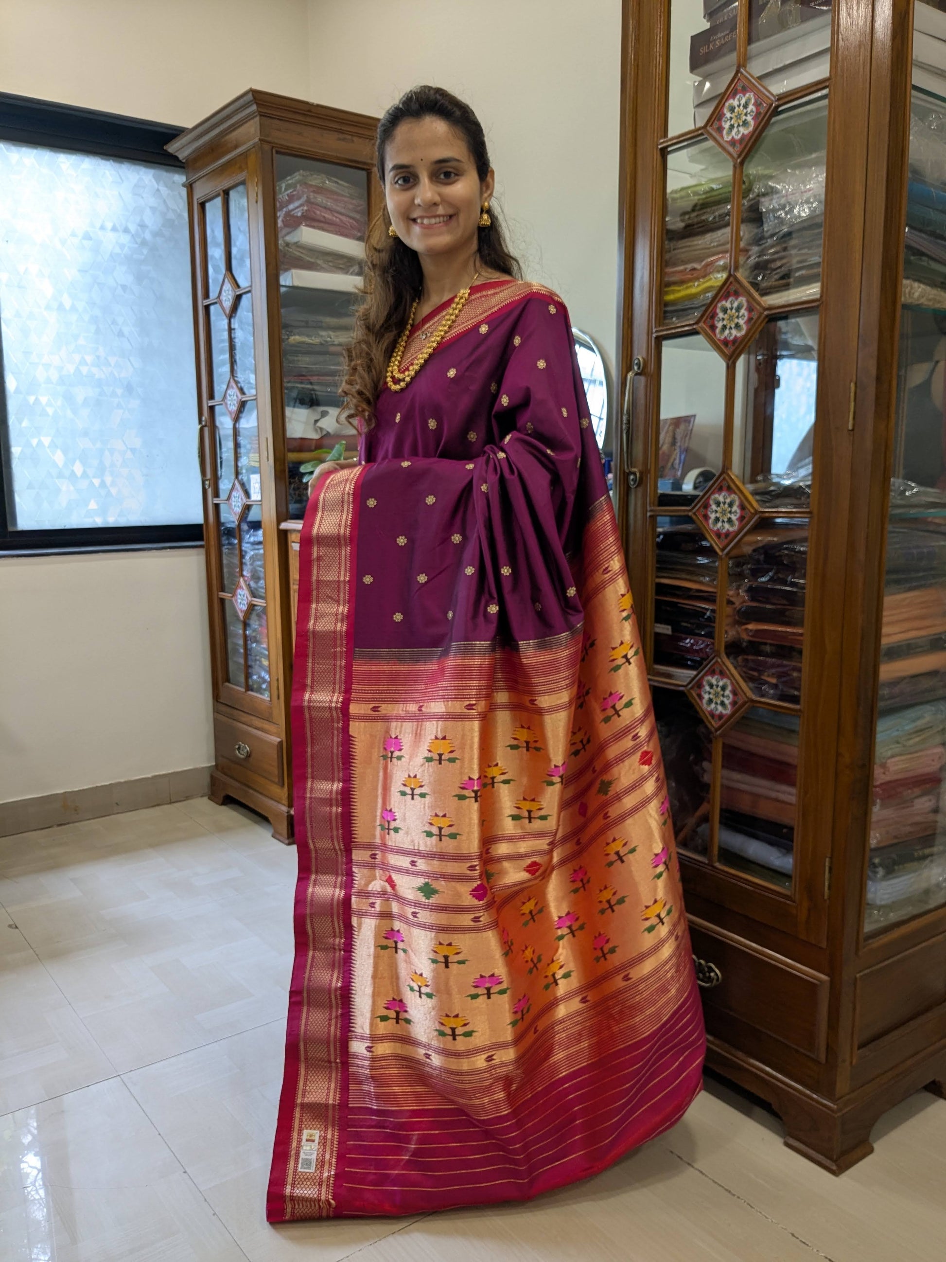 Full front view of rich deep magenta handloom Paithani saree featuring heritage flower patterns and intricate detailing.
