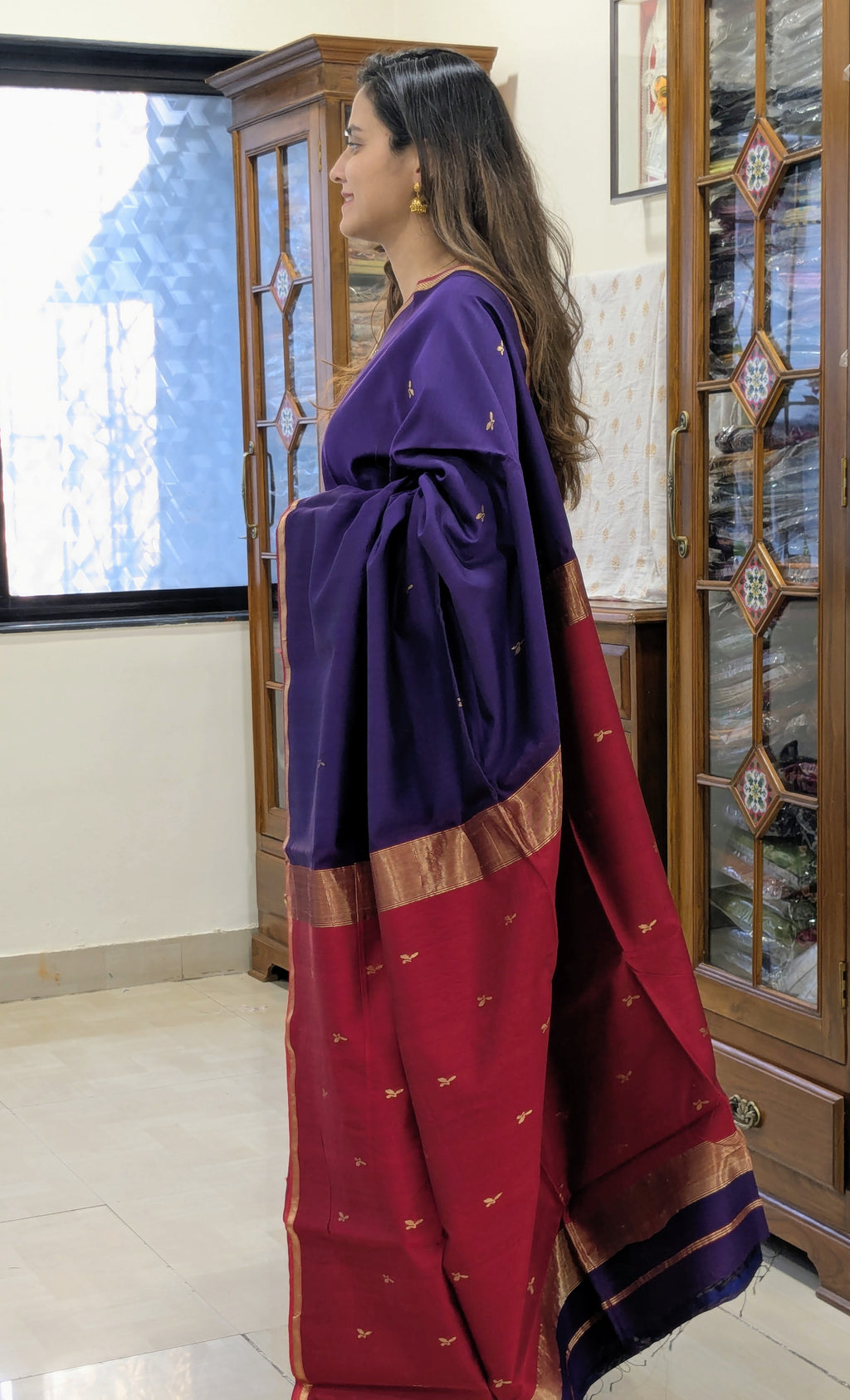 Woman wearing a purple and red saree