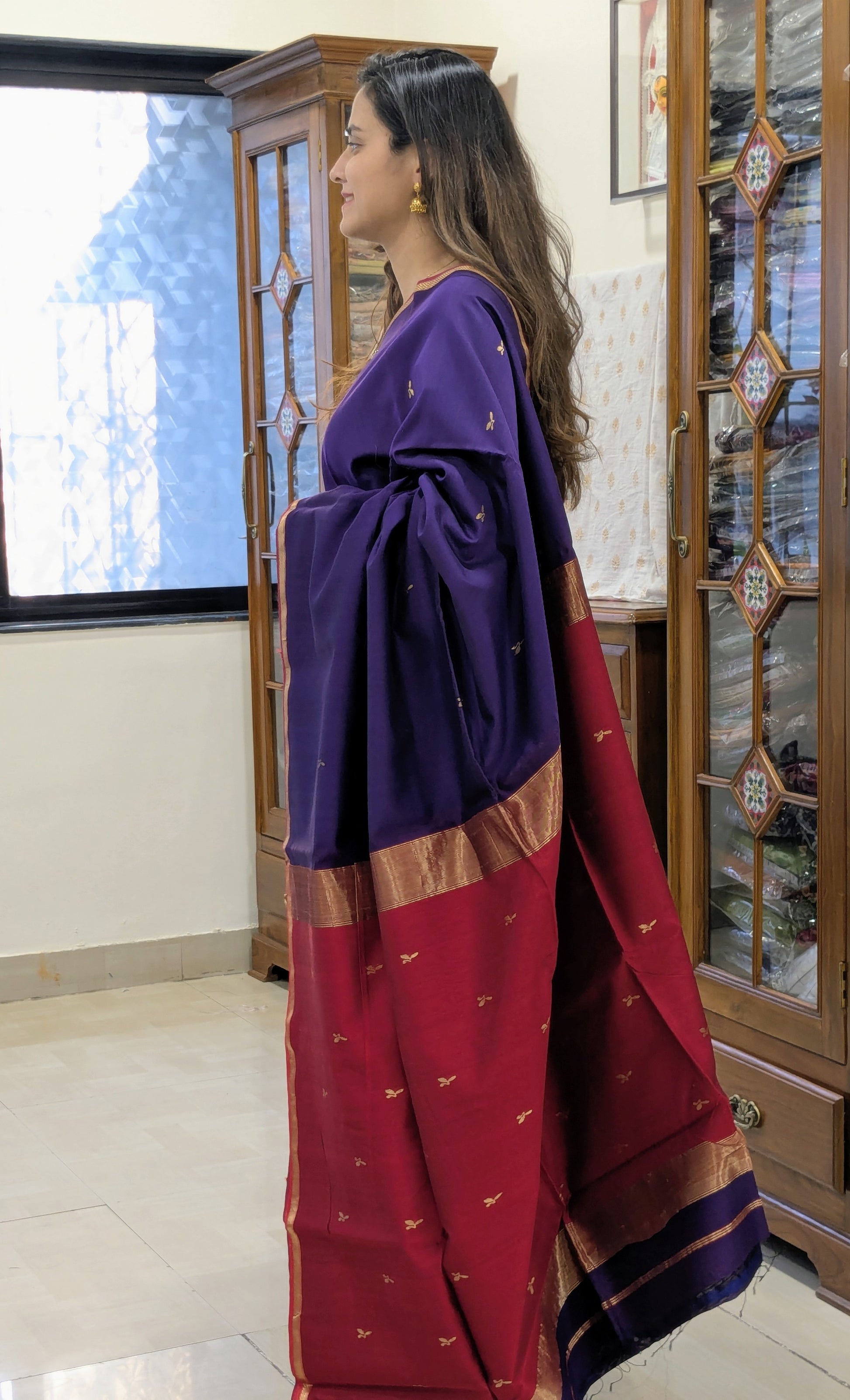 Woman wearing a purple and red saree