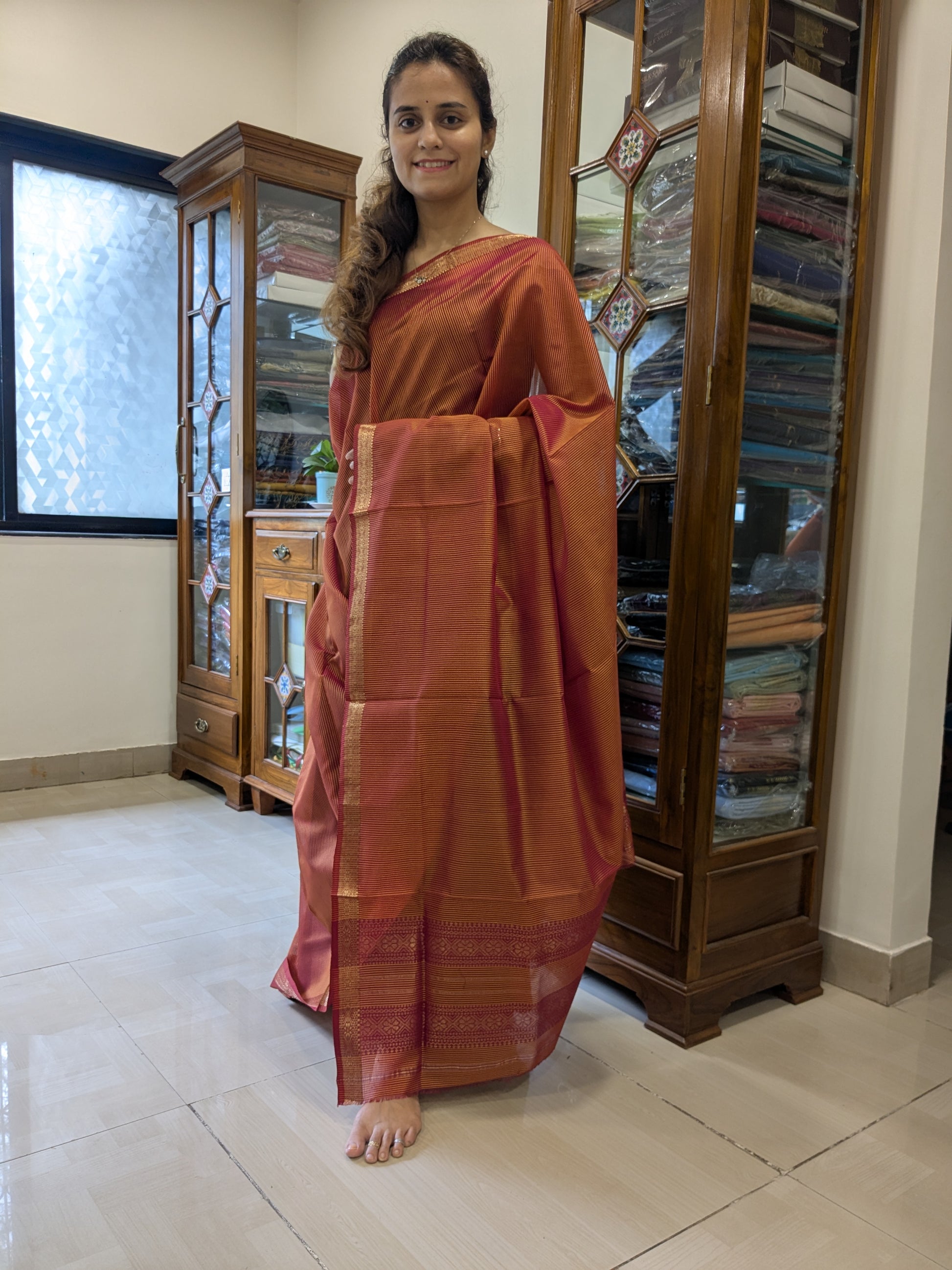 Full view of Light Orange silk-cotton saree highlighting traditional Maheshwari weave and soft festive glow.