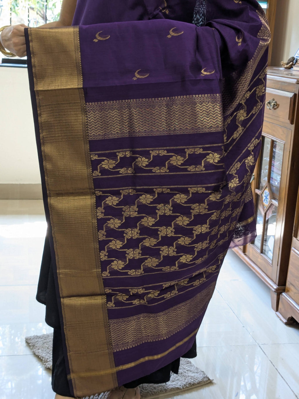 Detailed shot of heavy jaali pallu featuring ornate floral and celestial patterns in fine craftsmanship. 