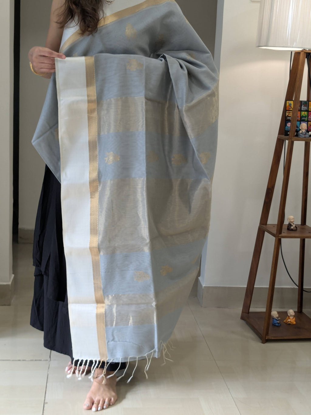 Detailed image of zari-lined pallu with delicate floral elements and understated shimmer.