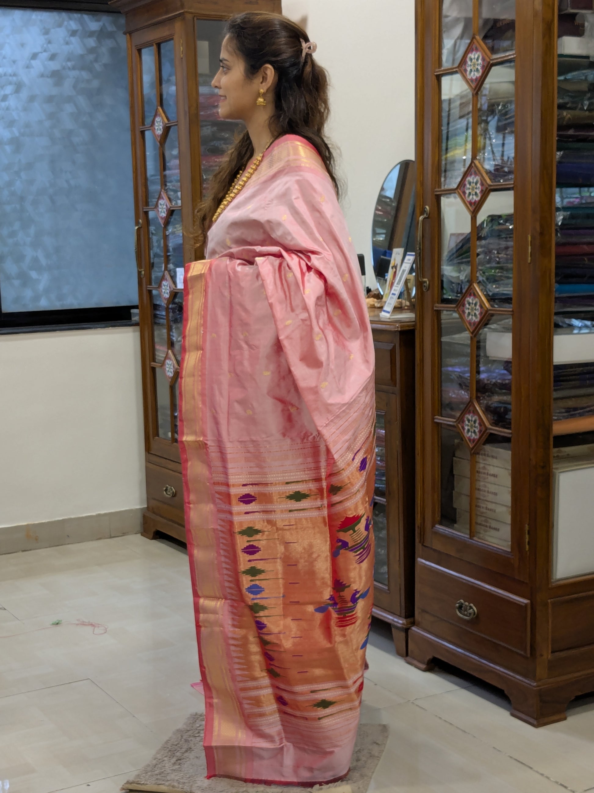 Side angle highlighting the sheen of 100% pure silk and the traditional narali border.