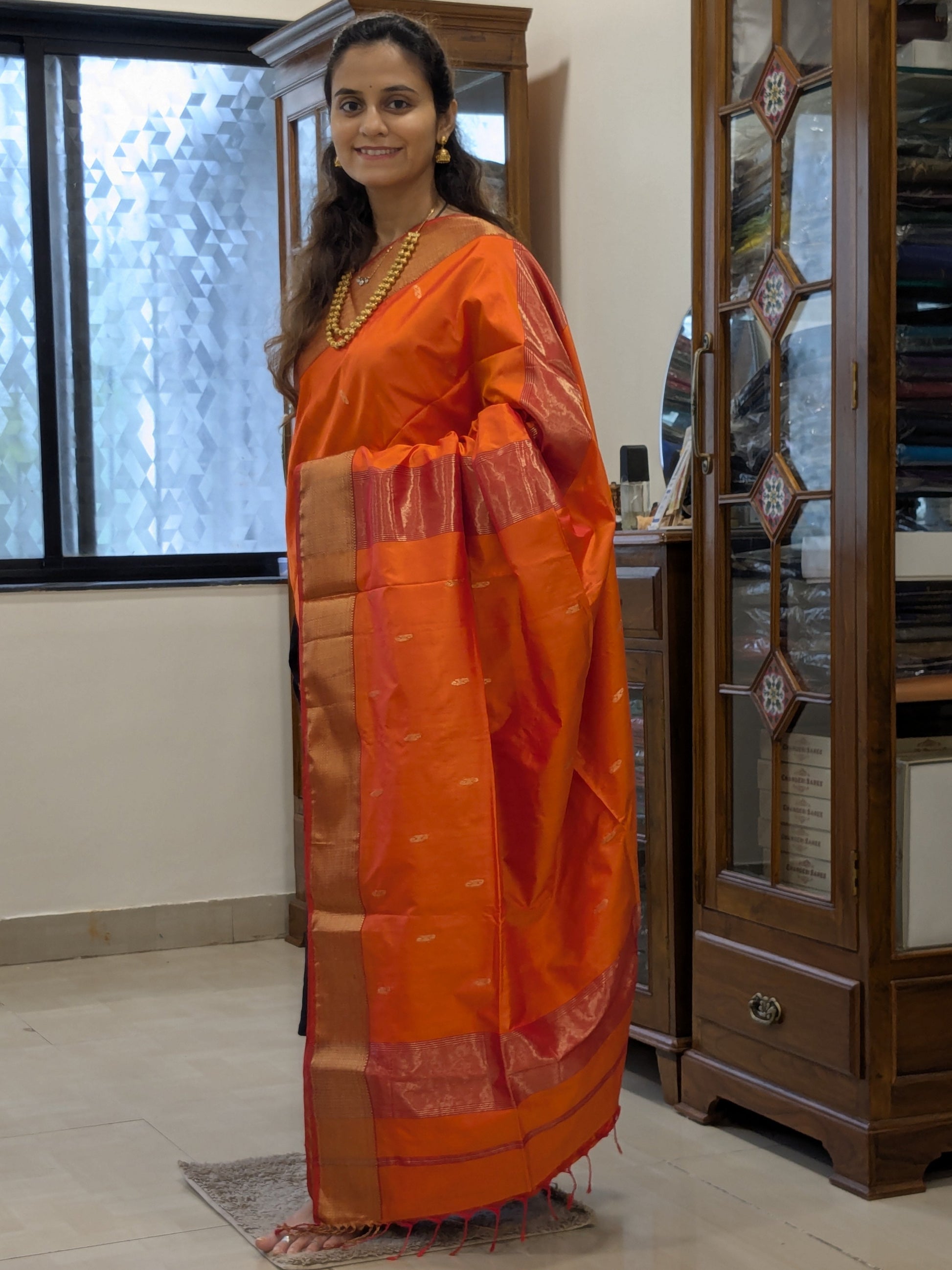Full front view of bridal-festive Sunset Orange Maheshwari saree in pure silk.