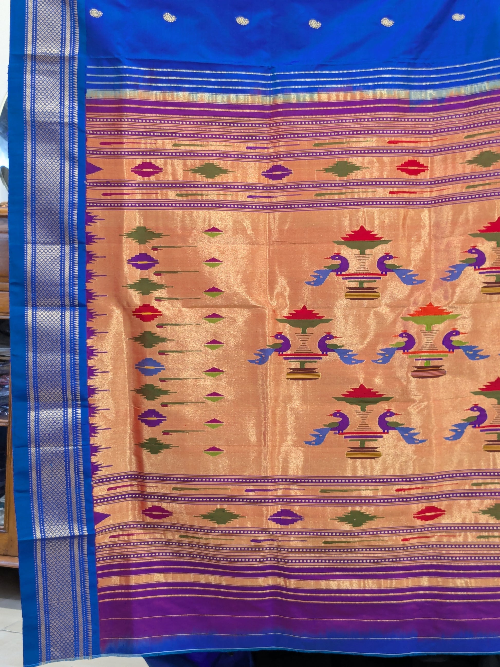 Detail of the pallu featuring vibrant handwoven peacocks – a bridal favourite.