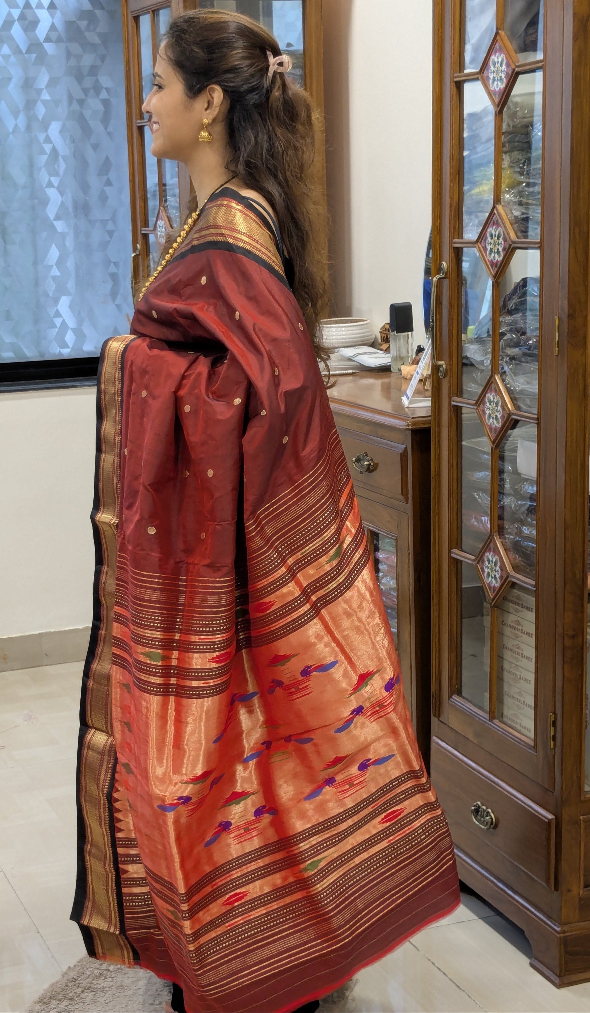Side view showcasing smooth silk drape and intricate handloom weave.