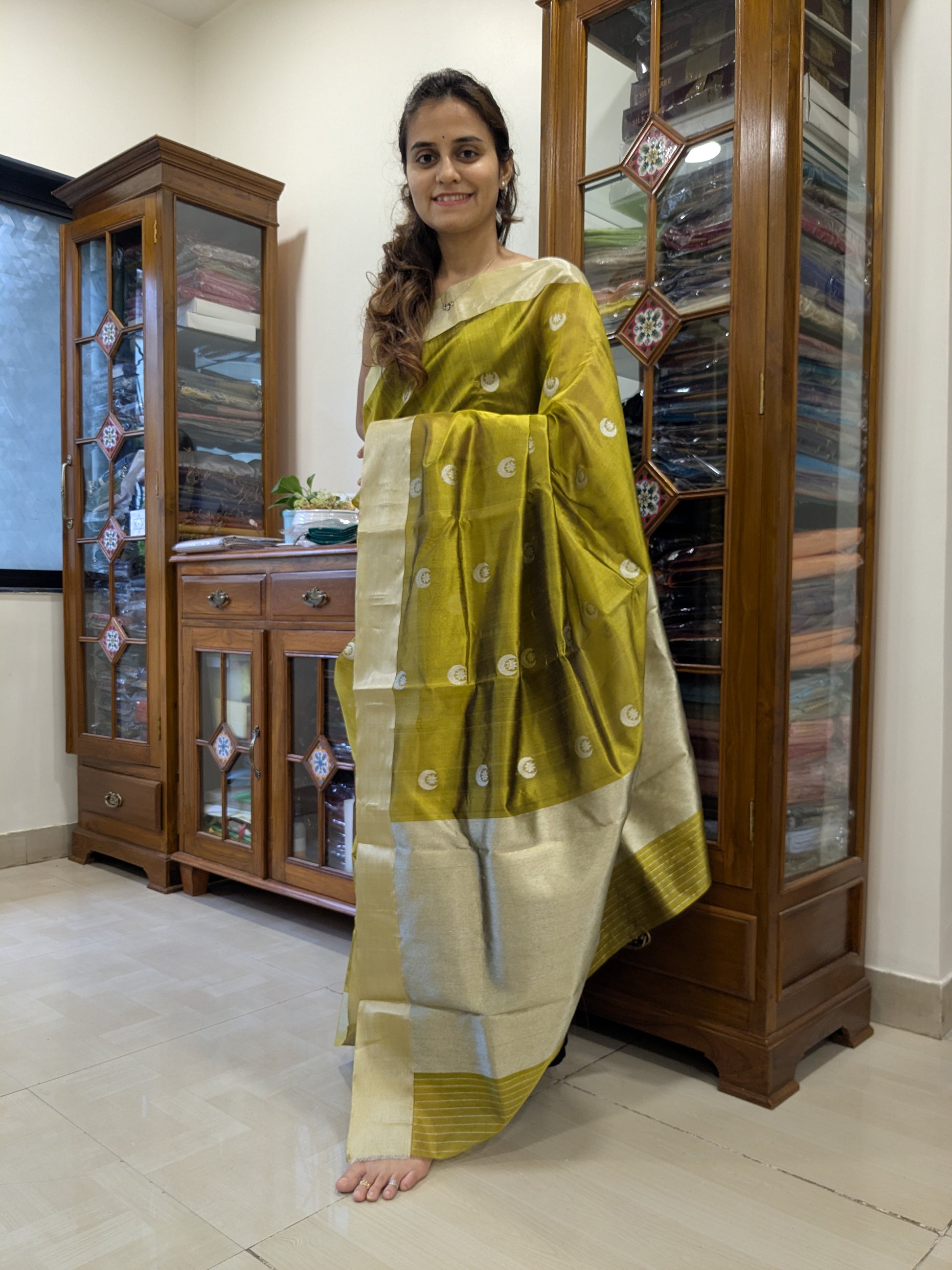 Full front view of festive mehendi green handloom Chanderi saree featuring intricate floral and lunar patterns.  