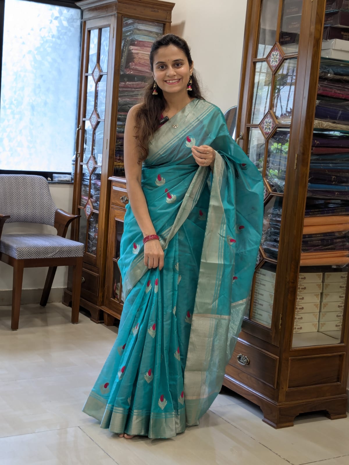 Full front view of festive rama green handloom Chanderi saree featuring delicate flower designs and rich texture.