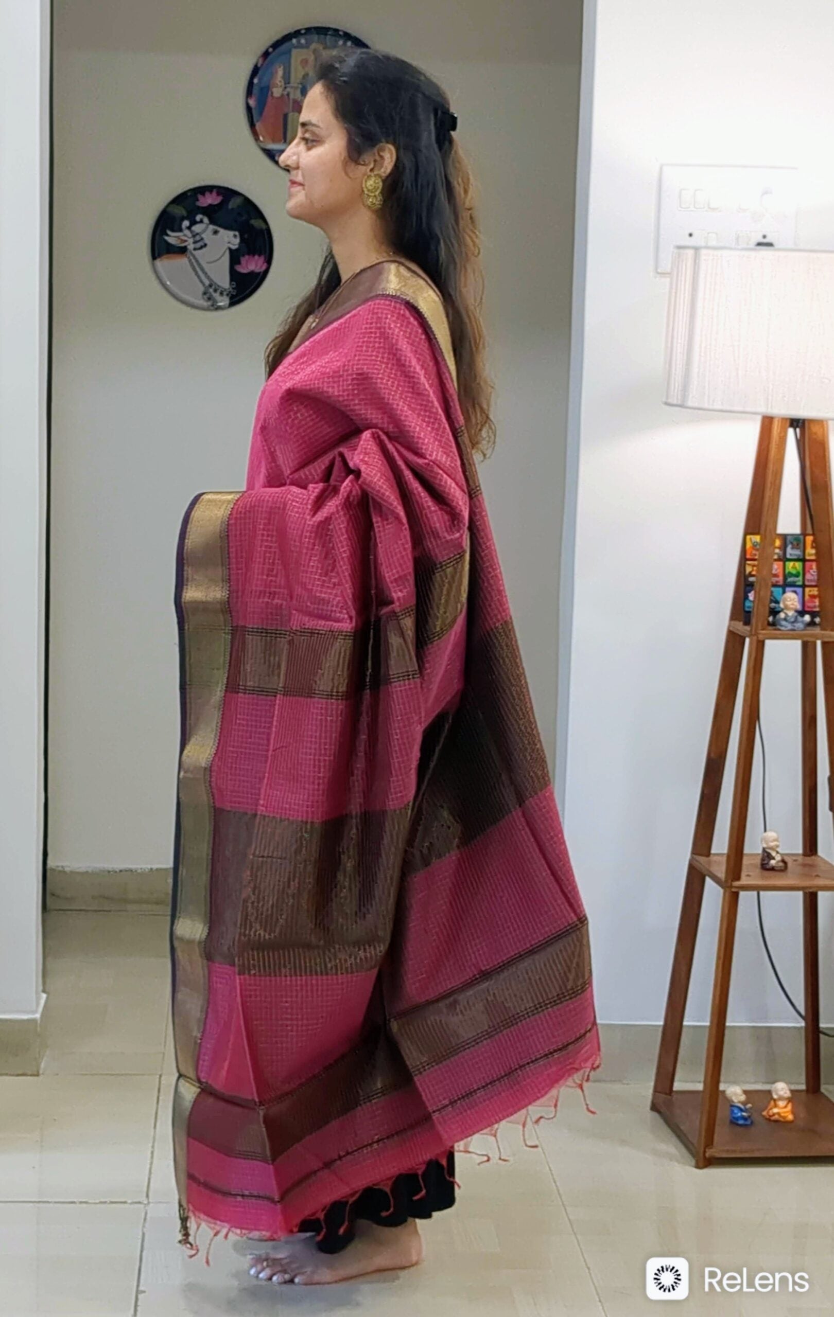 Side view of onion pink saree showing rich drape, traditional weave, and subtle shimmer.